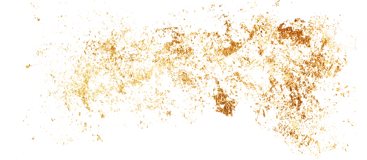 A close-up of a fragmented, golden-brown substance with scattered particles on a black background.
