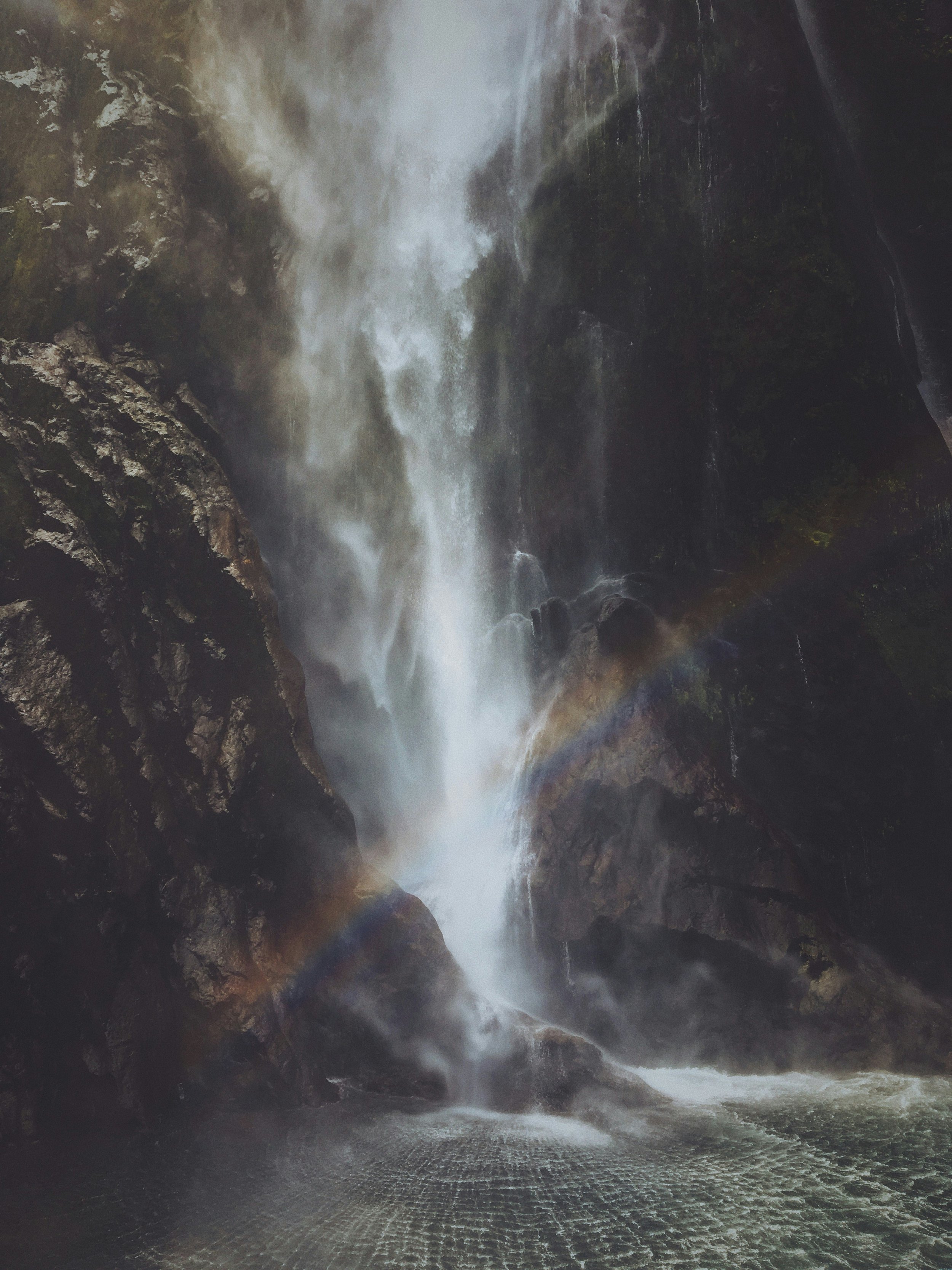 Powerful waterfall cascading down rocks representing the emotional release and somatic relief entrepreneurs experience when trapped energy finally moves through the body