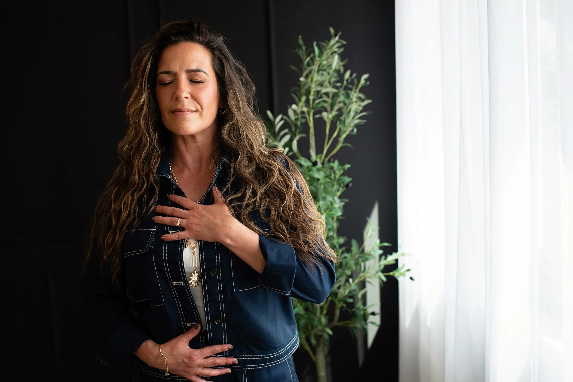 Chantal Menard, eyes closed, and a hand on her chest, appears to be experiencing emotion or feelings of longing.