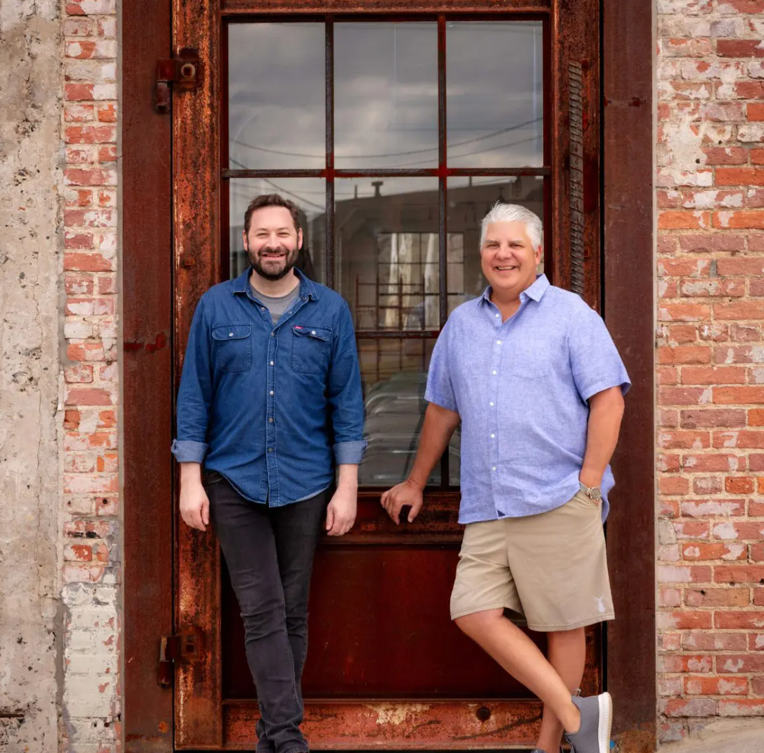 Bart Barlogie and Chris Tanner, owners of Eastside Scrapyard, standing in the doorway of the event space.
