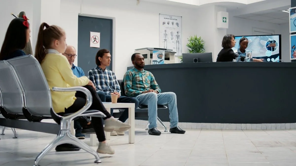 diverse-group-people-waiting-hospital-reception-lobby-attend-medical-appointment-with-general-practitioner-patients-waiting-room-lobby-sitting-healthcare-clinic-tripod-shot (1).jpg