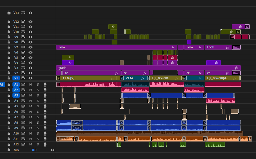 Digital audio workstation screen with multiple tracks in various colors, including waveforms, effects, and editing tools.