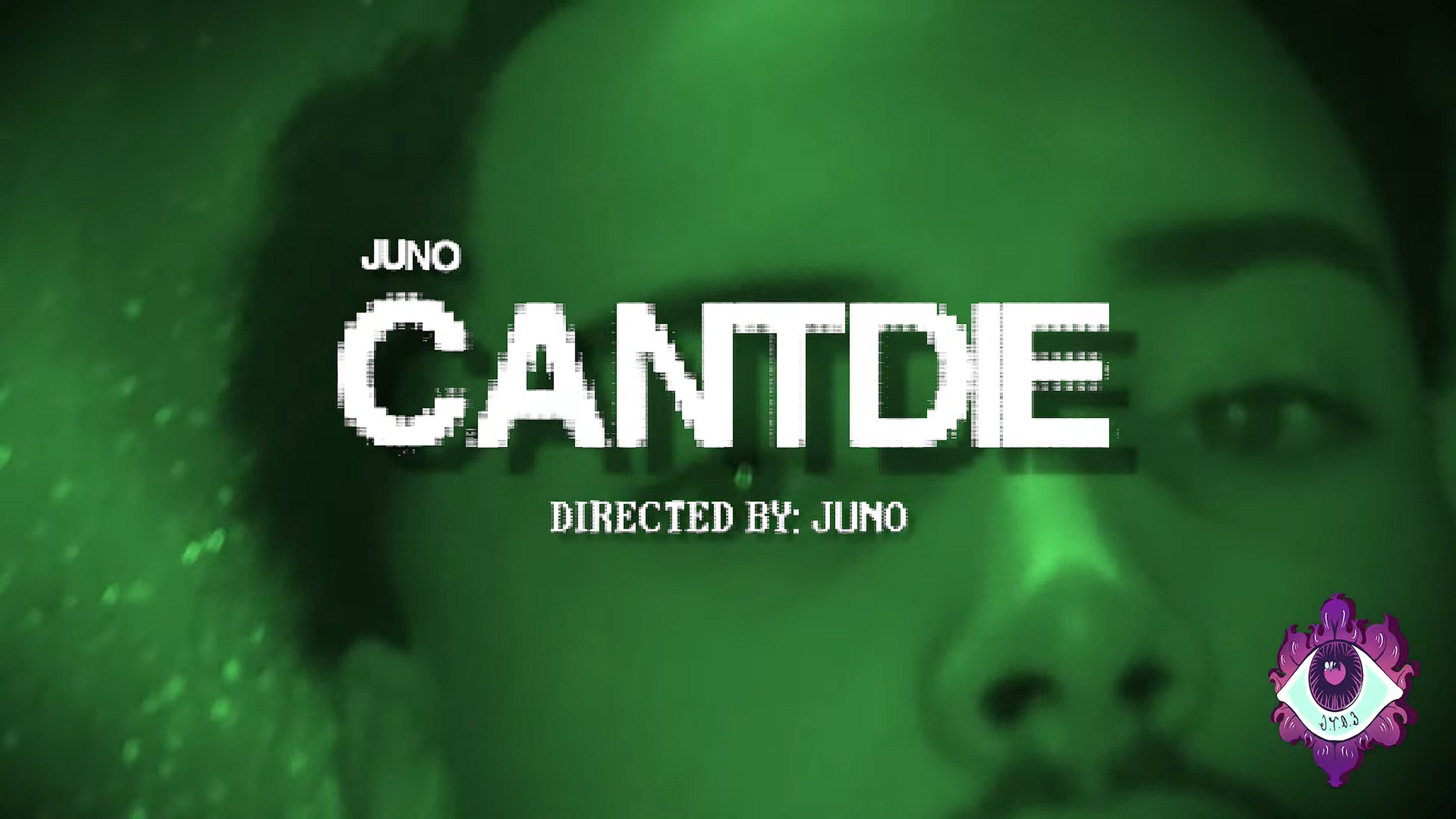Title screen with green background displaying the words 'Juno CANTICLES' and 'Directed by: Juno', along with decorative purple and white emblem in the bottom right corner.