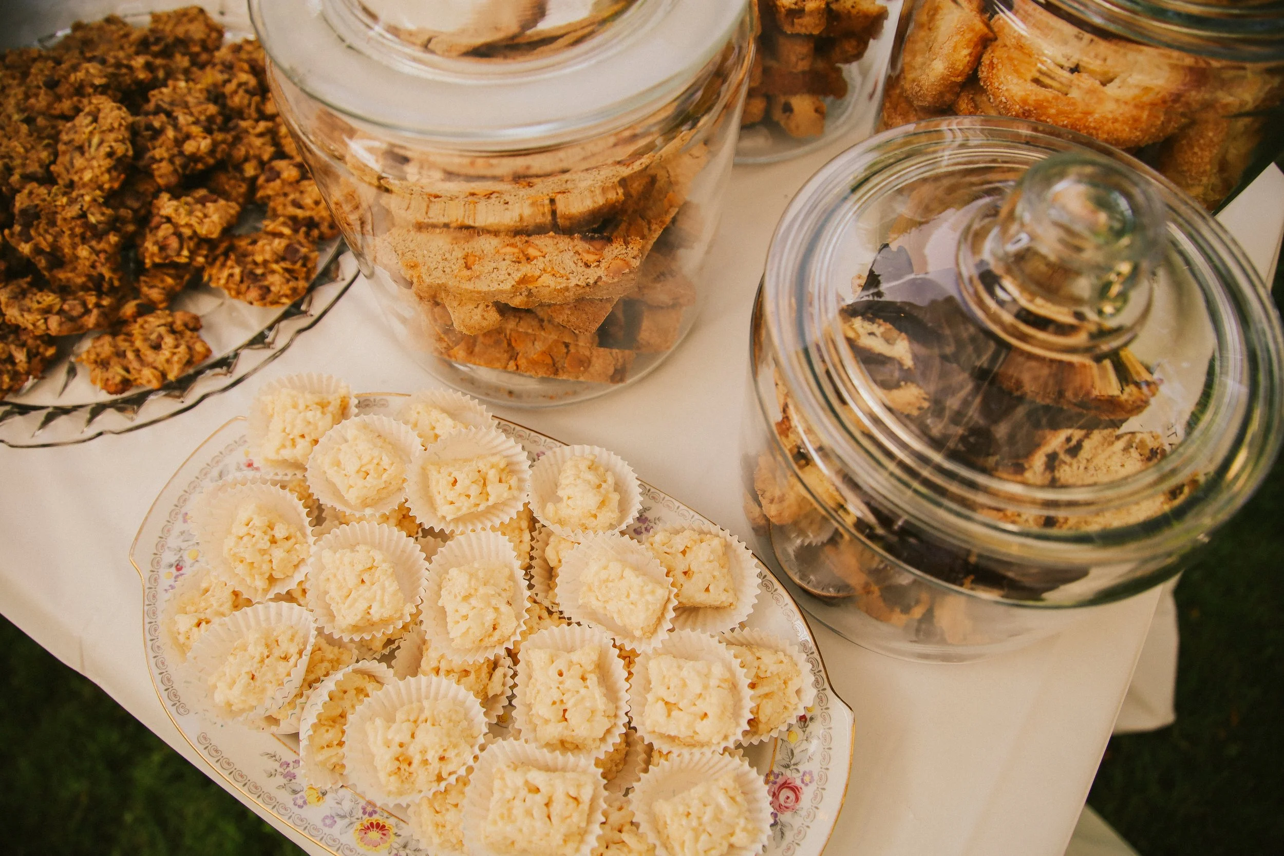 Assorted cookies on a decorative plate and in glass jars