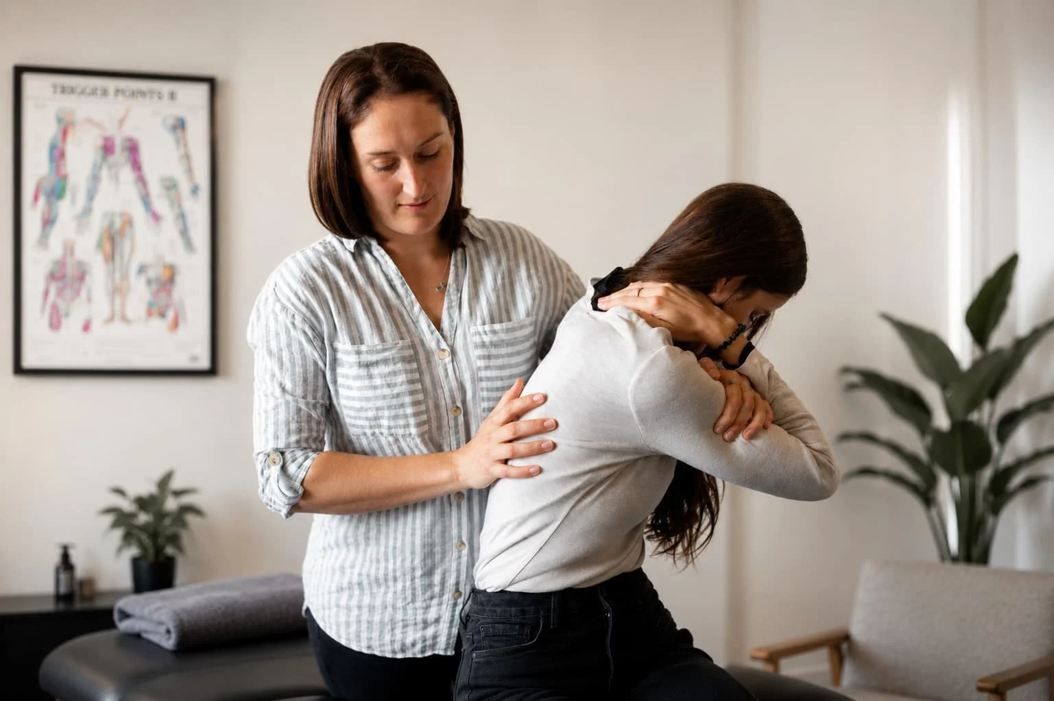 Osteopath Rosalind Hill assessing a patient’s upper-body movement in a treatment room.