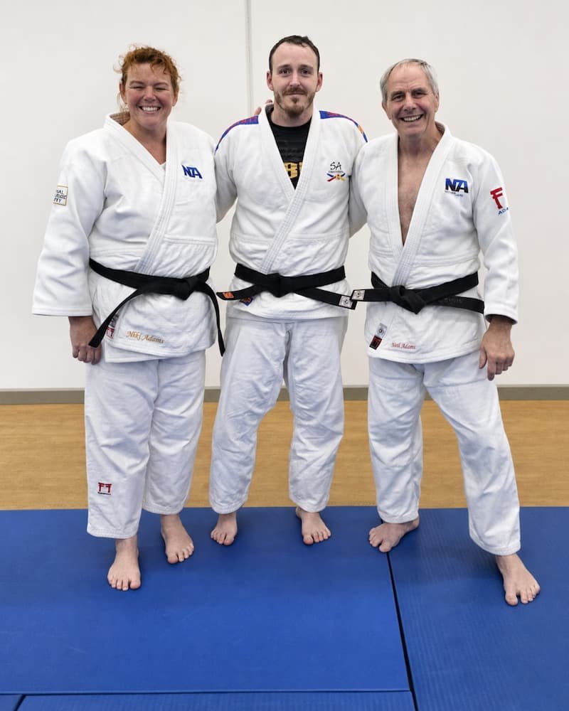 Dr Joshua Saxton with judo champions and coaches Neil and Niki Adams at a judo seminar.