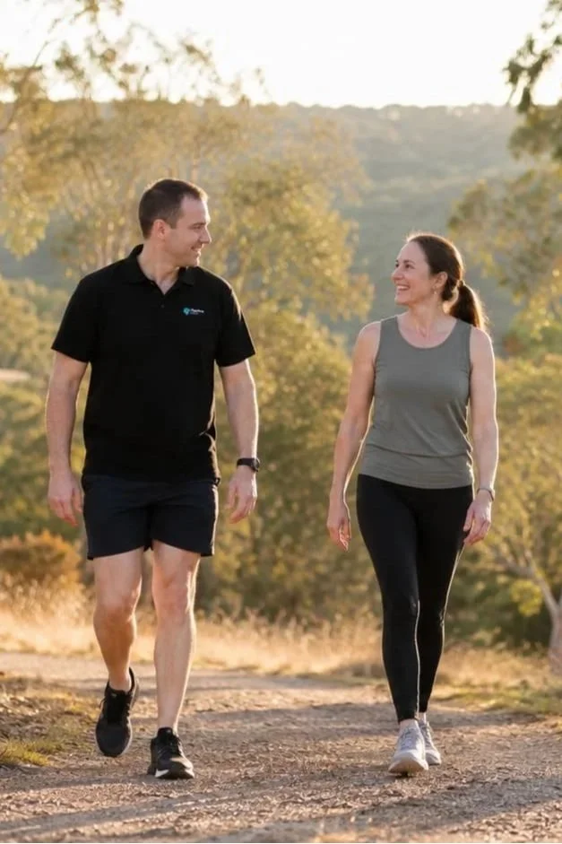 Dr Joshua Saxton walking with a patient on a bush trail in the Adelaide Hills, representing an active return to everyday life.