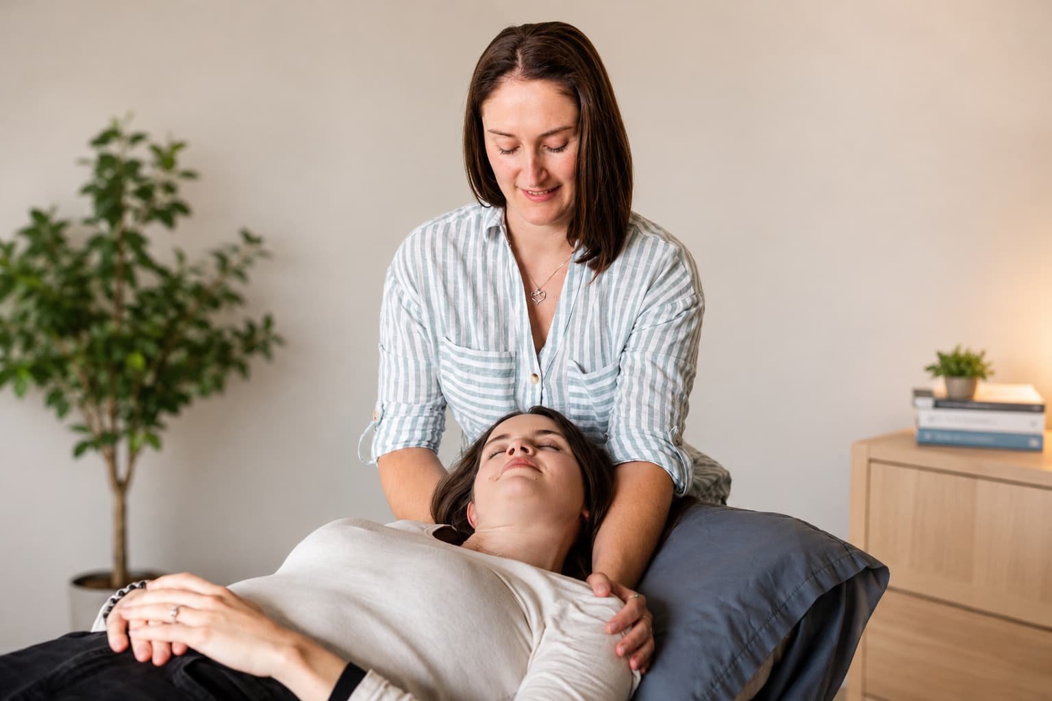 Osteopath providing hands-on neck and shoulder treatment during a personalised osteopathy consultation at Live Better Be Stronger in Adelaide.