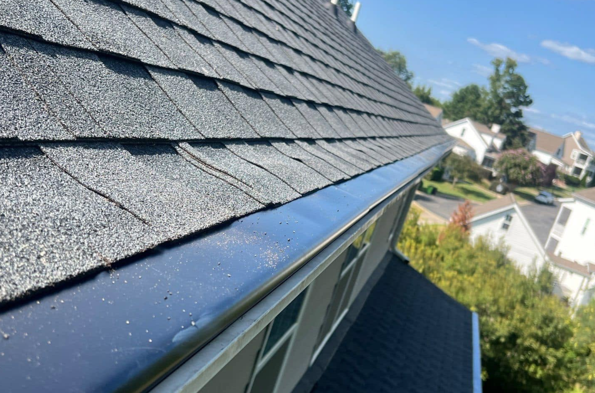 Custom Aluminum Gutter guards installed on asphalt shingle roof