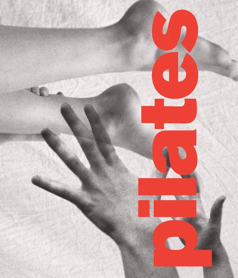 Black and white photograph of two hands, one reaching out and the other touching the fingers, with bold red text reading "pilates" written vertically across the image.
