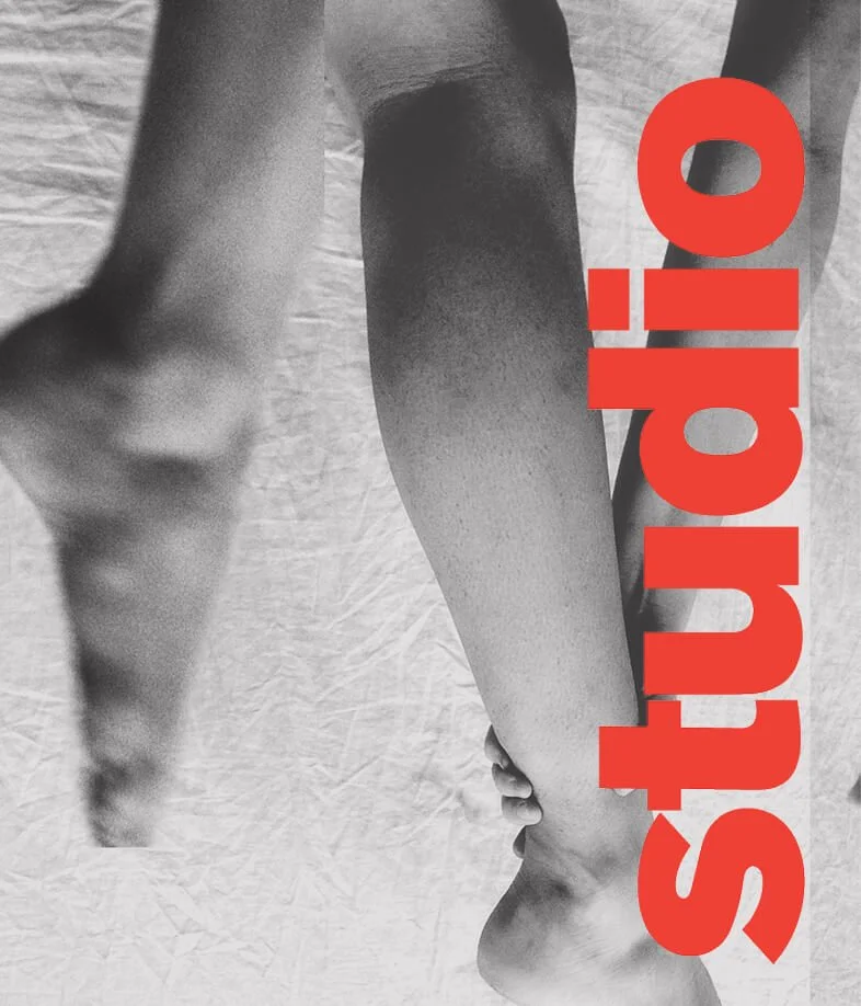 Black and white photo of a person's hand and arm, with the word "studio" written in large red letters vertically across the image.