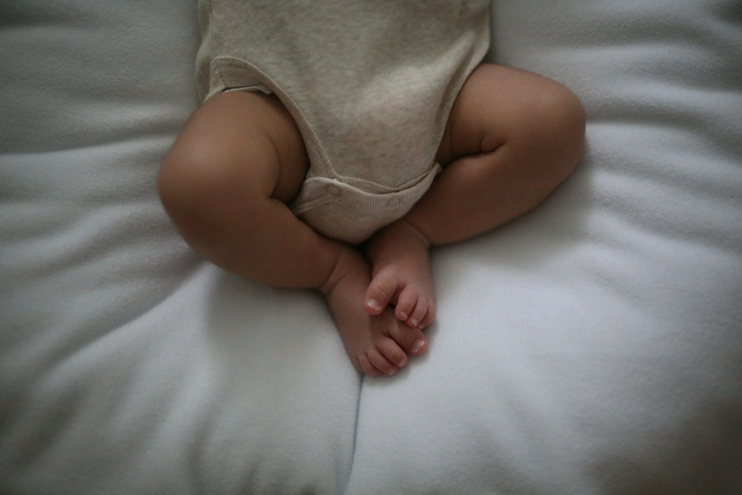Postpartum Doula caring for a newborn during an in-home visit in Iowa City, Iowa