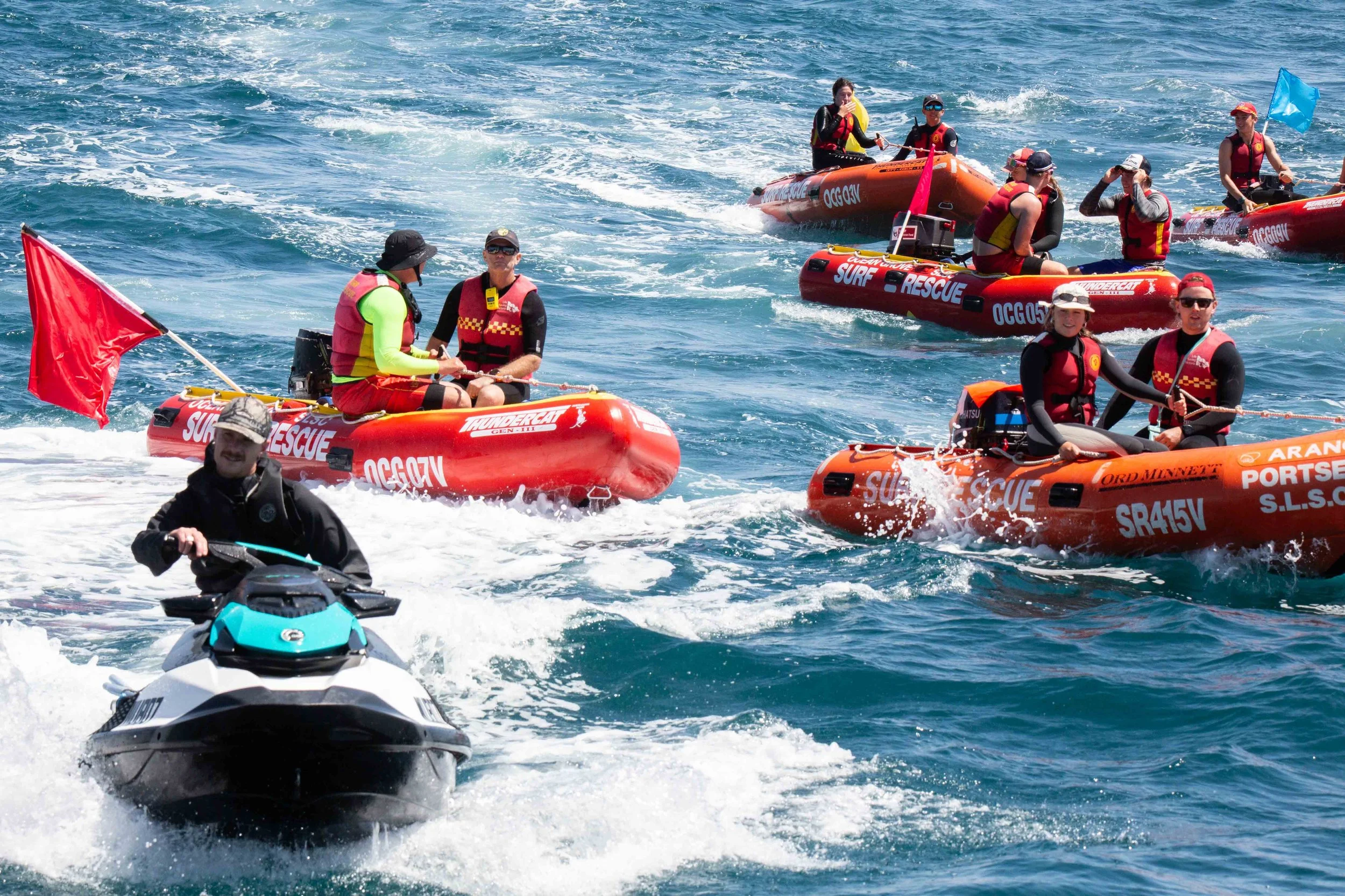 Group of water-safety team members irom Ocean Grove Surf Life Saving Club doing their job during The Rip Swim crossing.