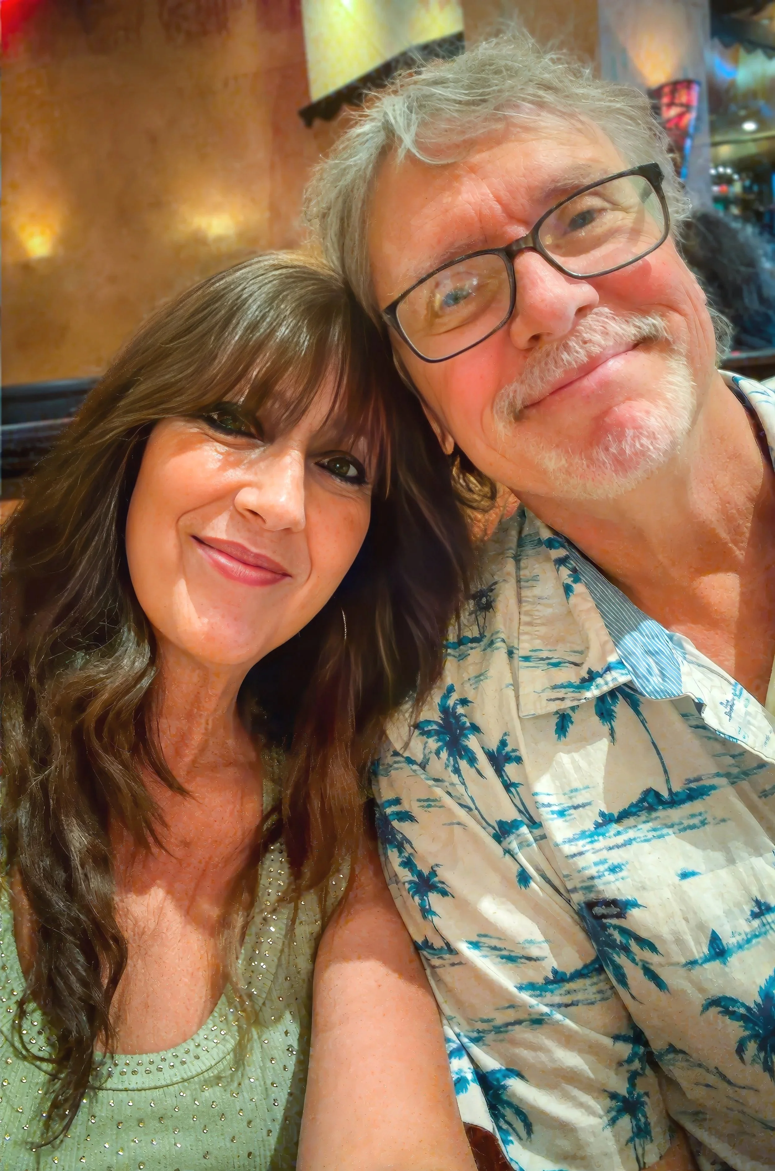 Pastor Tom Crouse and his wife Gina Crouse, both in a restaurant with warm lighting and colorful decor.