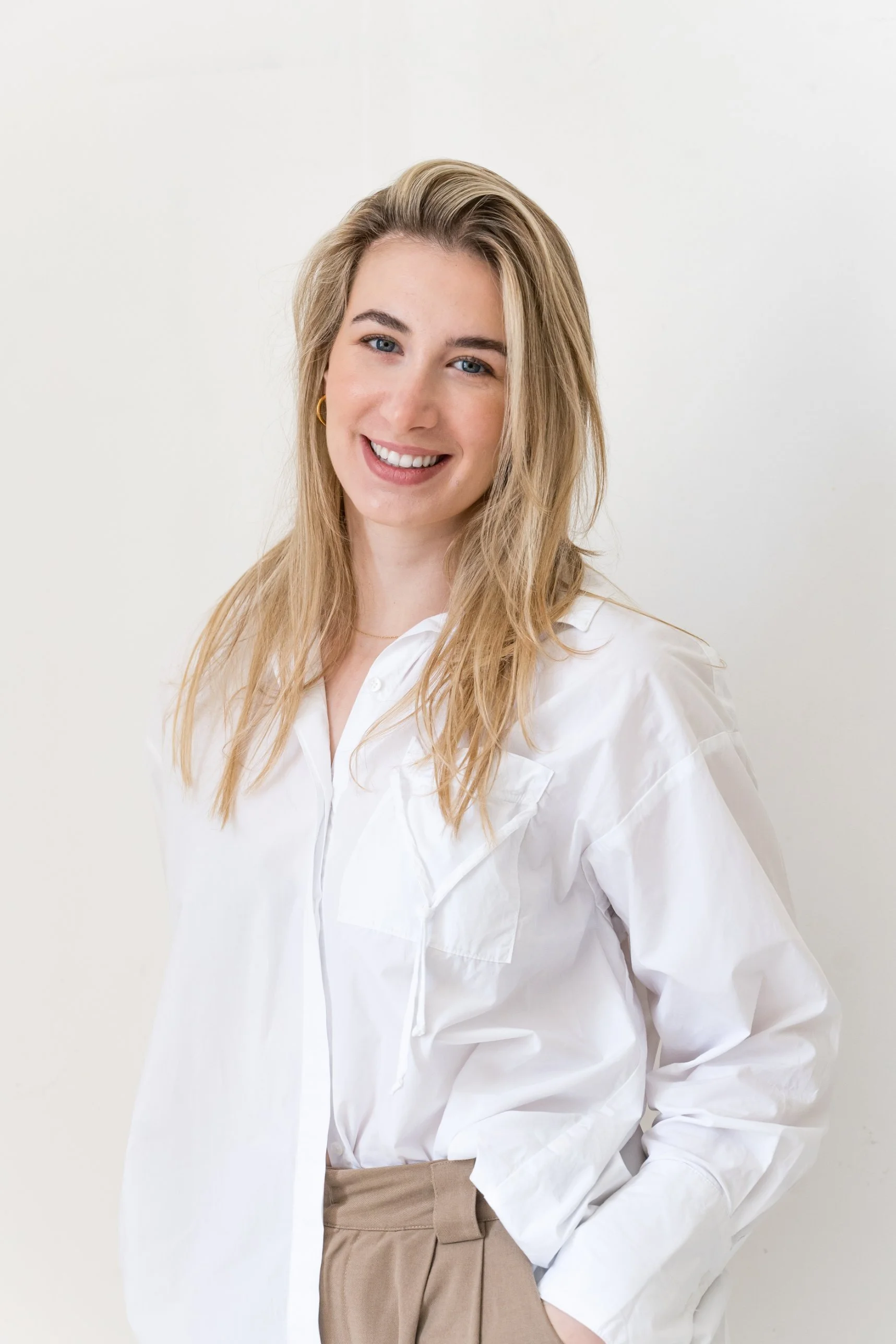 Lauren Poulos, psychologist, smiling in a white shirt