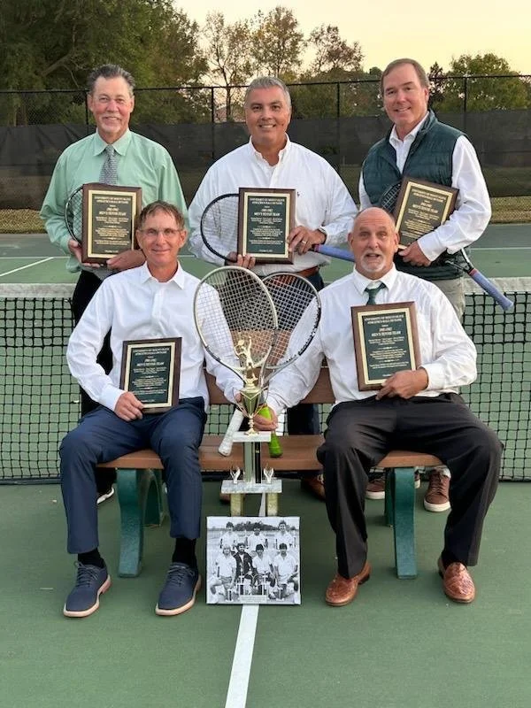 Michael Bowen and his 1982 tennis teammates holding plaques and a large trophy, being inducted to University of Mount Olive's Hall of Framer.