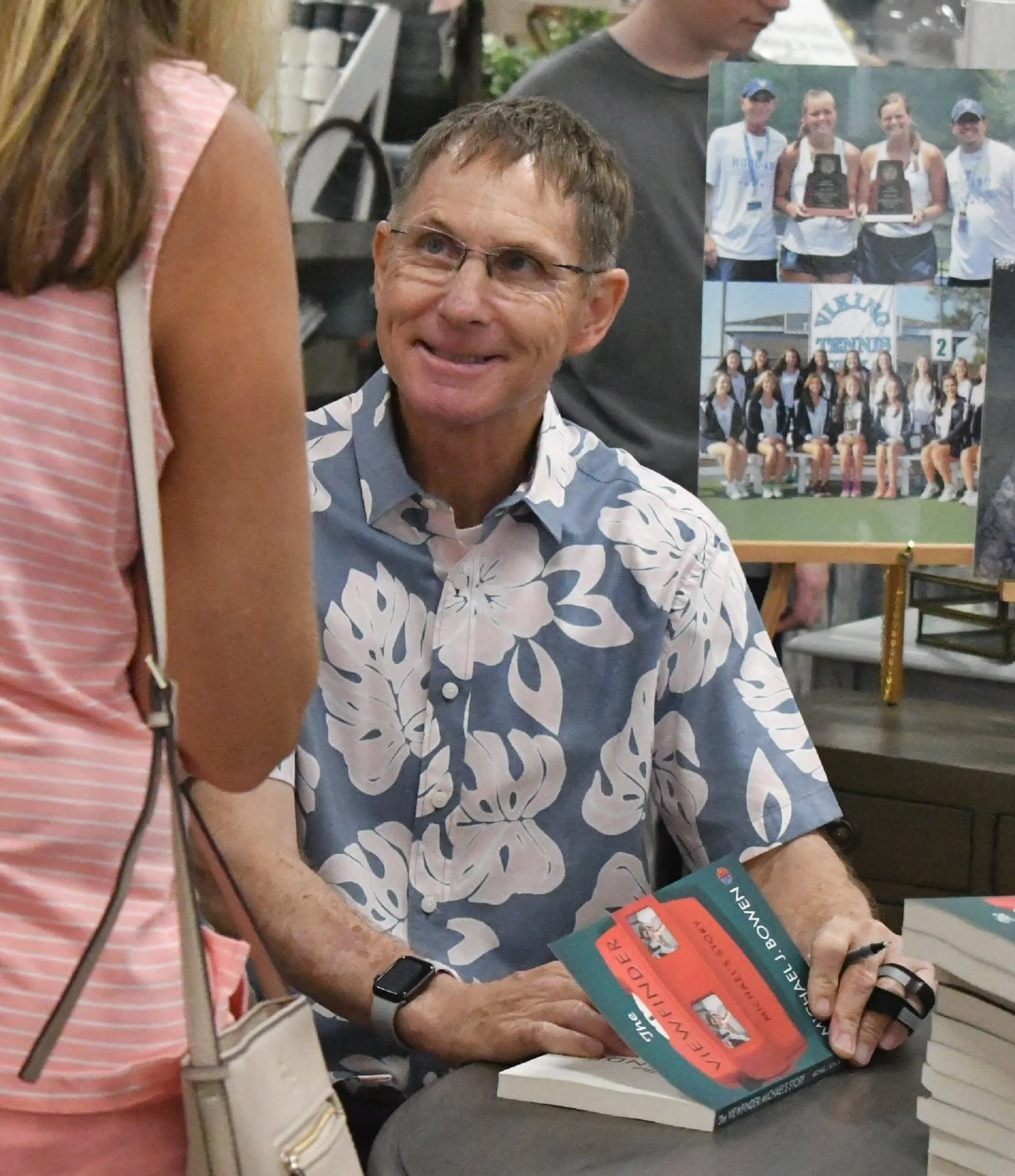 Michael J. Bowen speaking to a reader on a book signing event.