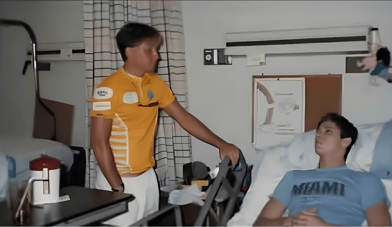 Michael J. Bowen visiting a patient lying down on a hospital bed.