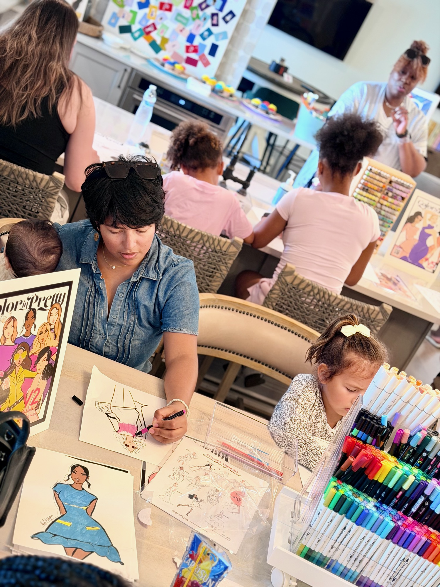 Host and children coloring together at a private group coloring party event