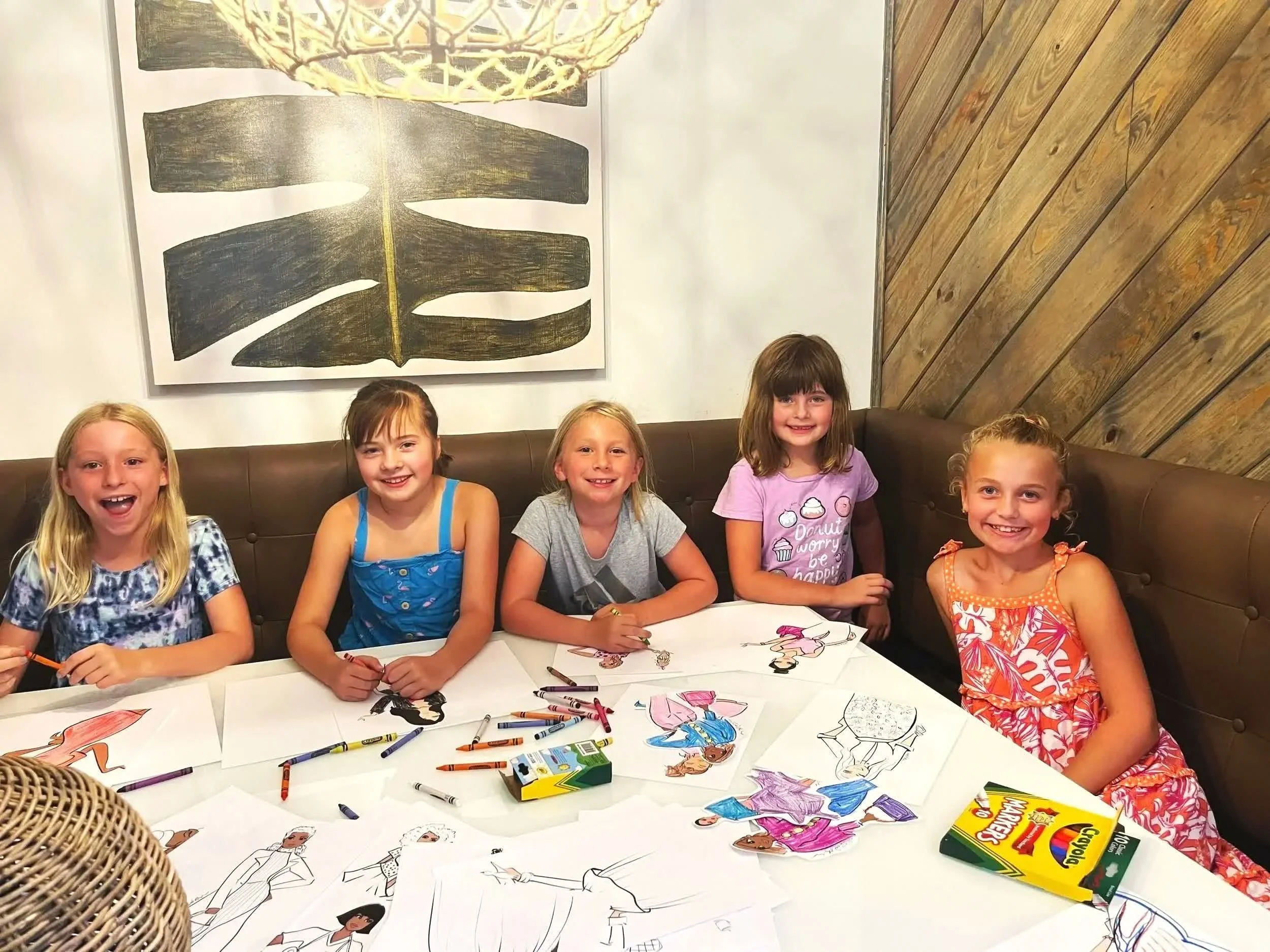 Kids coloring The Dollies pages together at a Color In Pretty coloring party event