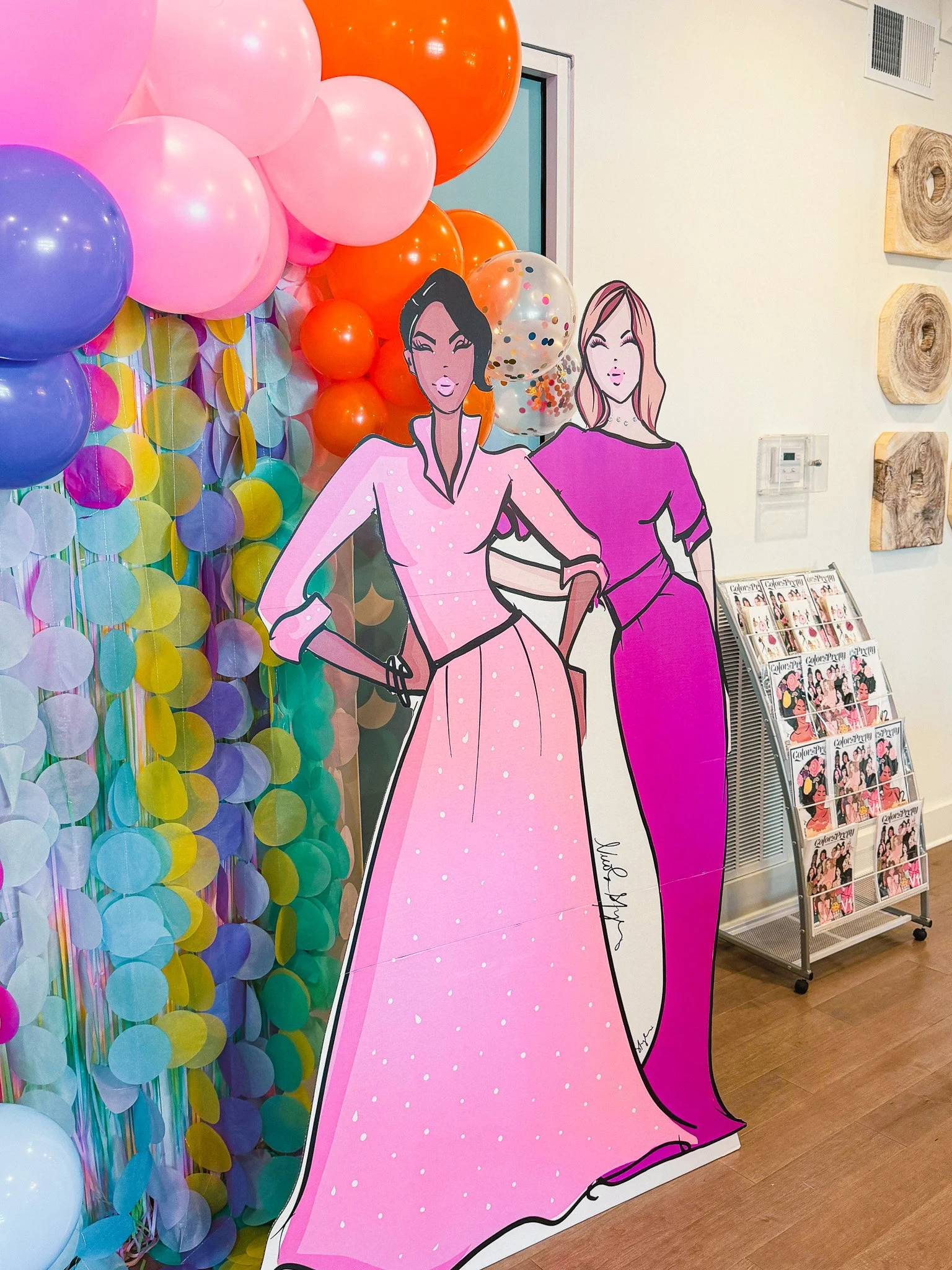 Group photo at a Color In Pretty community event with balloon arch