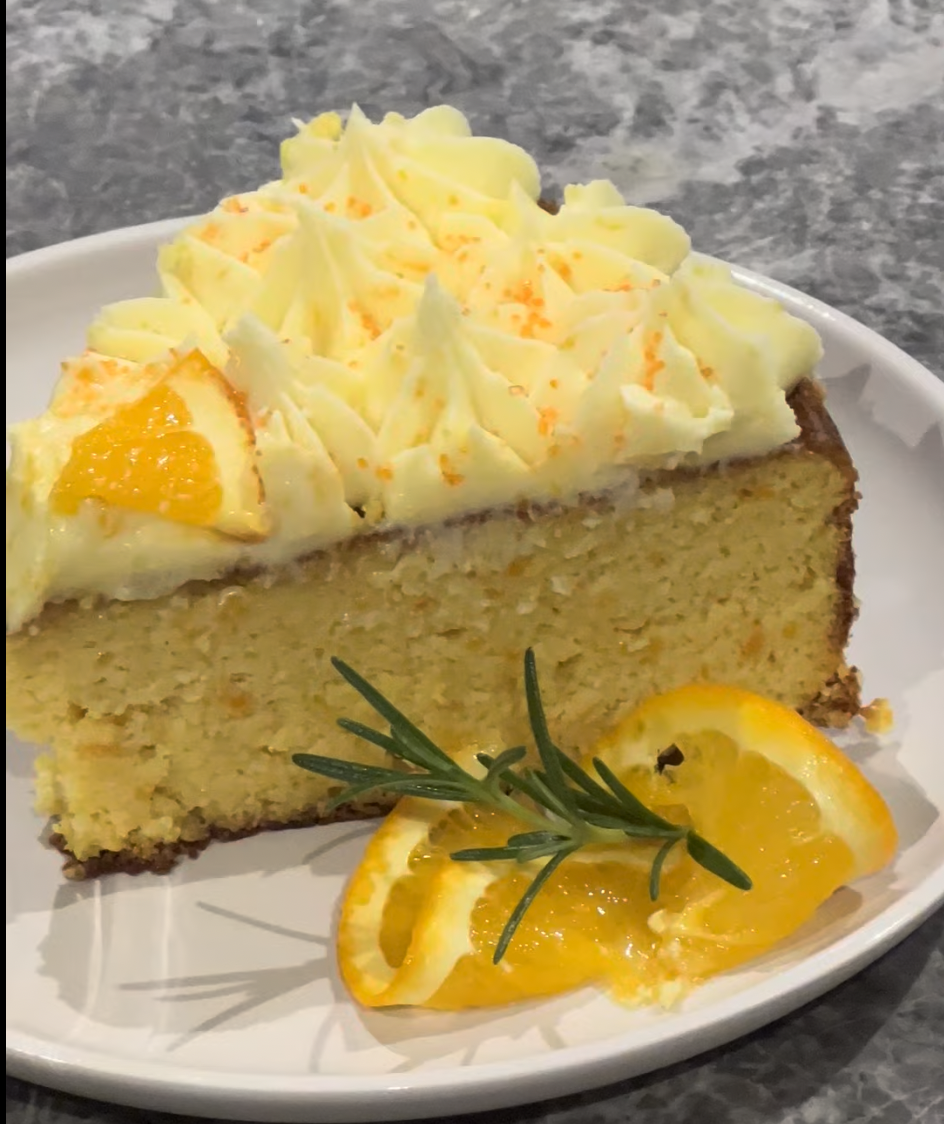 Slice of Flourless Orange Cake topped with a soft Orange Flavoured Buttercream