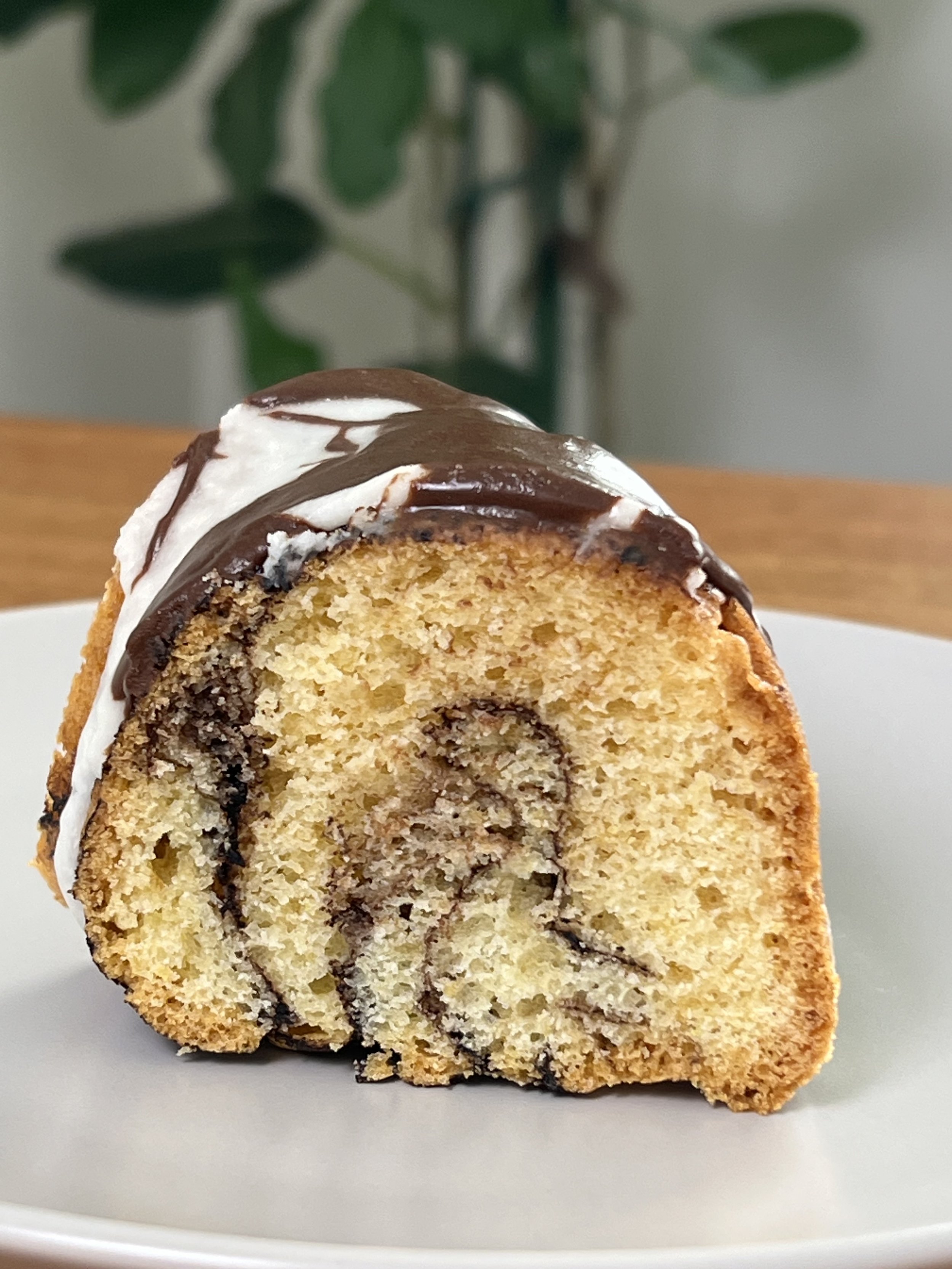 Slice of Gluten-Free Chocolate & Vanilla Marble Cake covered in Chocolate and Vanilla Ganache