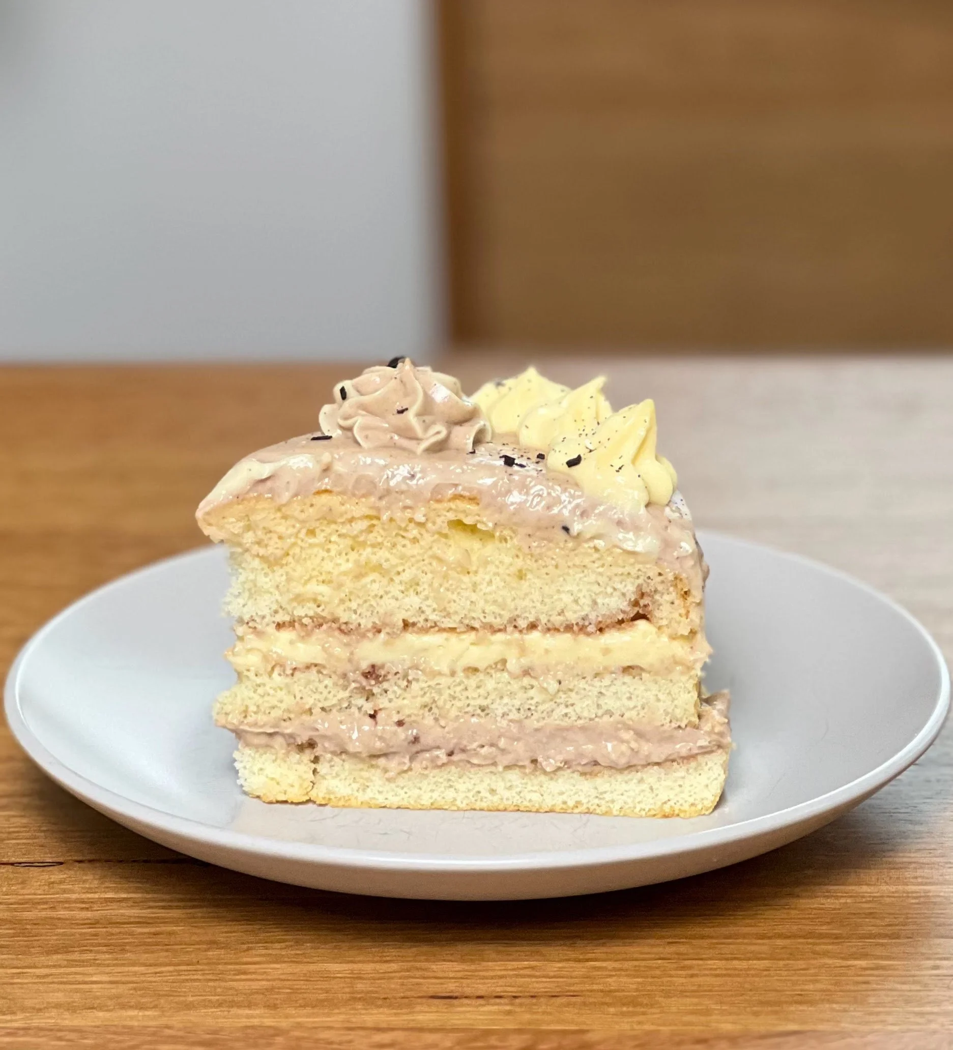 Slice of Gluten-Free Vanilla Sponge layered with Vanilla and Chocolate Buttercream