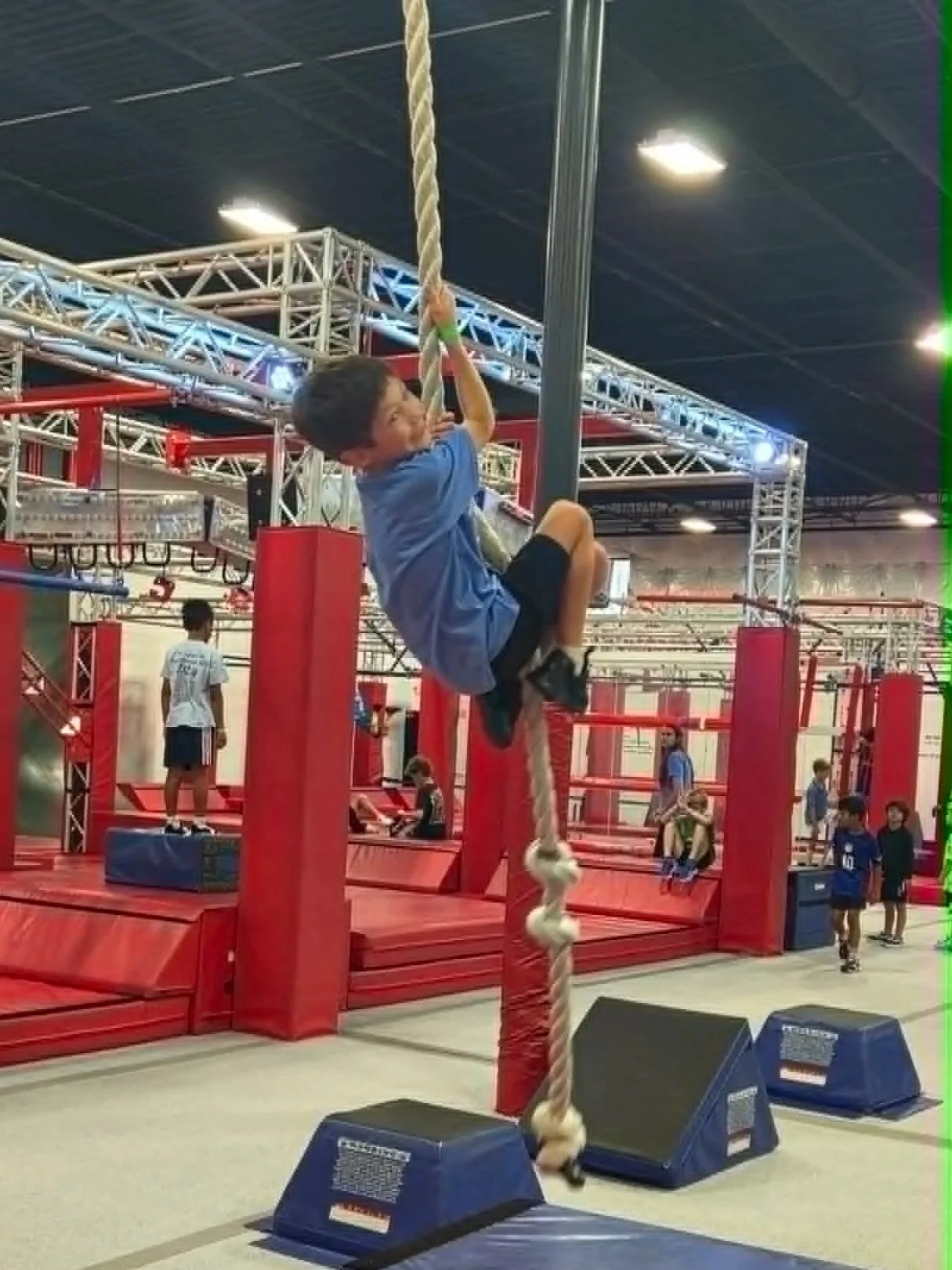 Child climbing a rope during Open Gym at Octo Ninja
