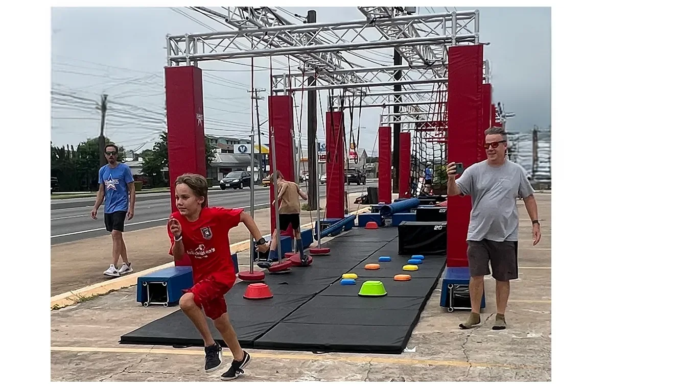 Child racing through an Octo Ninja Mobile obstacle course