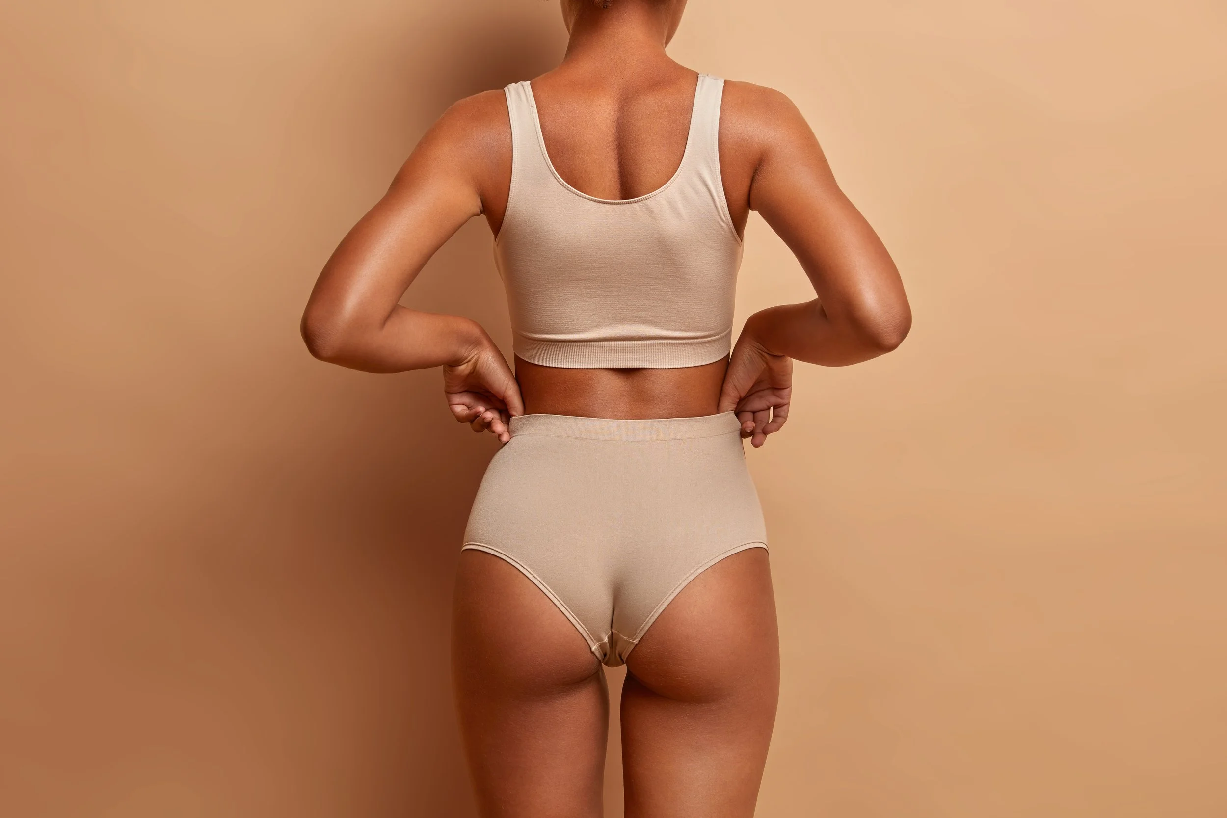 Client wearing shapewear after non-invasive booty lift treatment