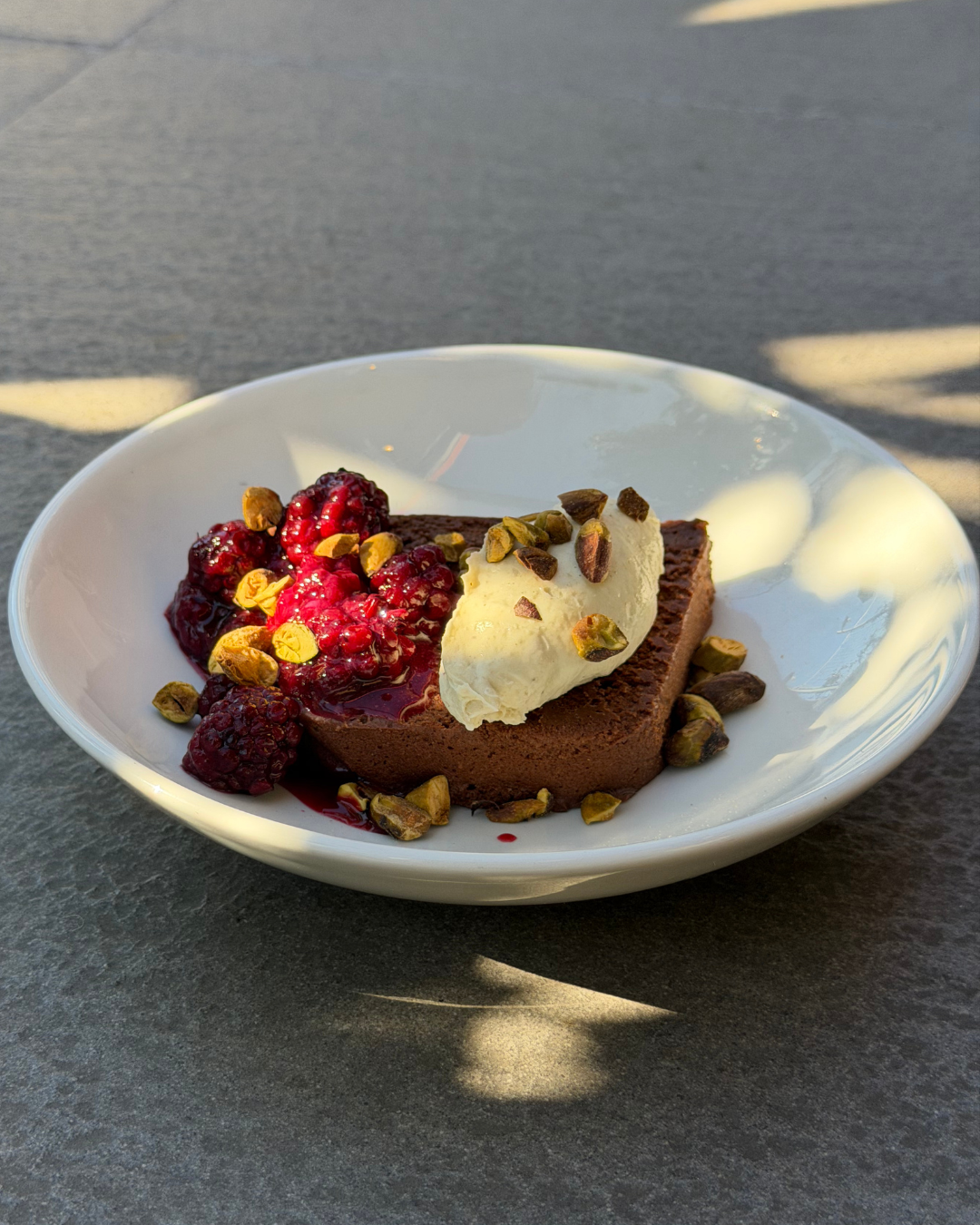 Dark chocolate terrine w. autumn blackberries & pistachio