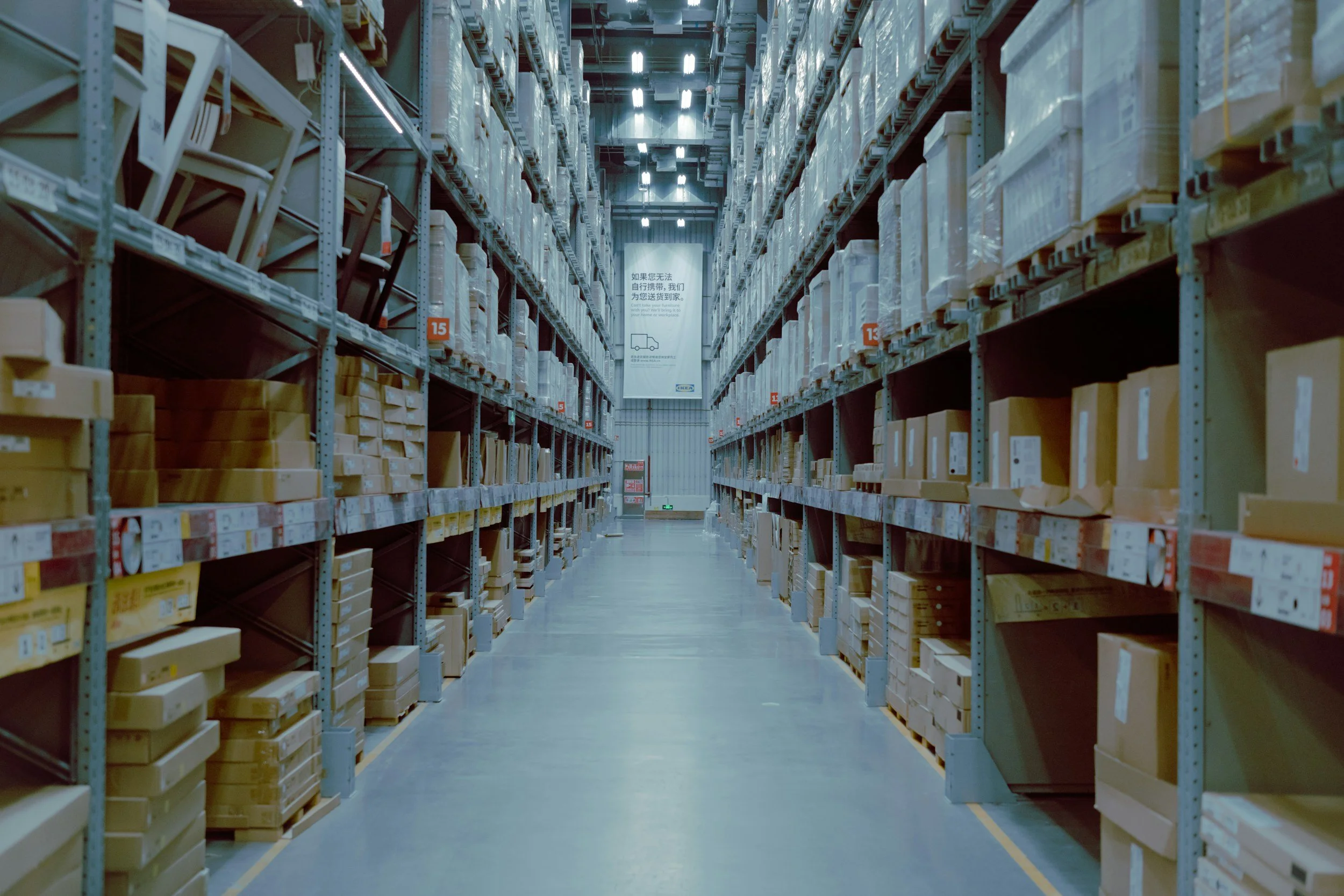 Large warehouse aisle with organized wholesale inventory and storage racks