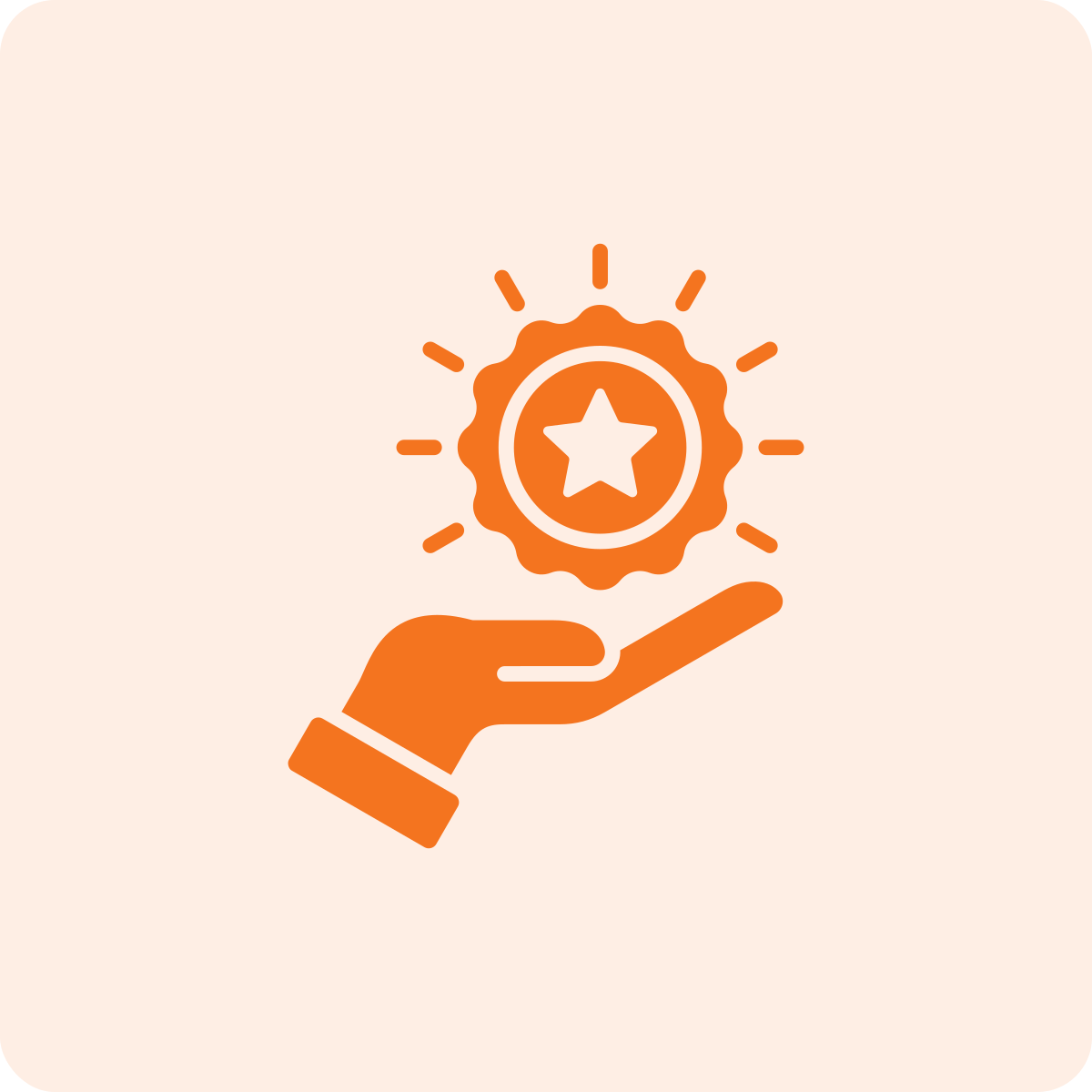 A hand holding a medal with a star in the center, radiating lines around the medal.