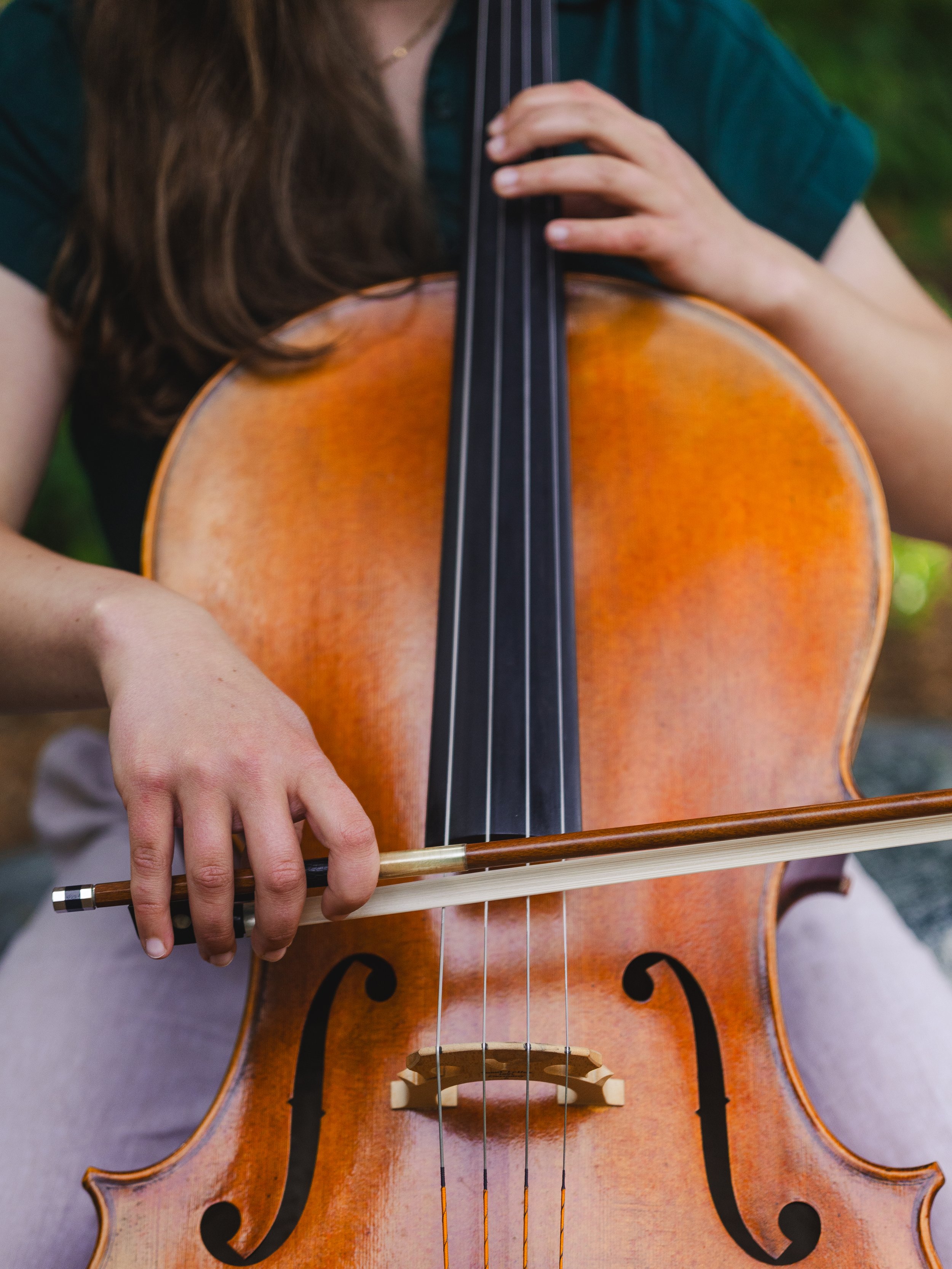 Close-up of Liz Mathiesen playing cello.