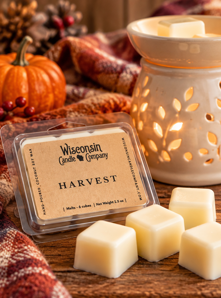 Harvest scented wax melts displayed beside a decorative wax warmer with pumpkins, cinnamon sticks, and autumn home décor.