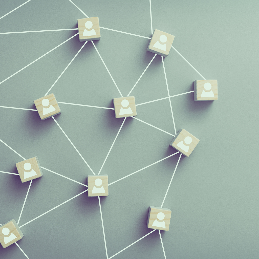 Network of interconnected white squares with user profile icons on a gray background.
