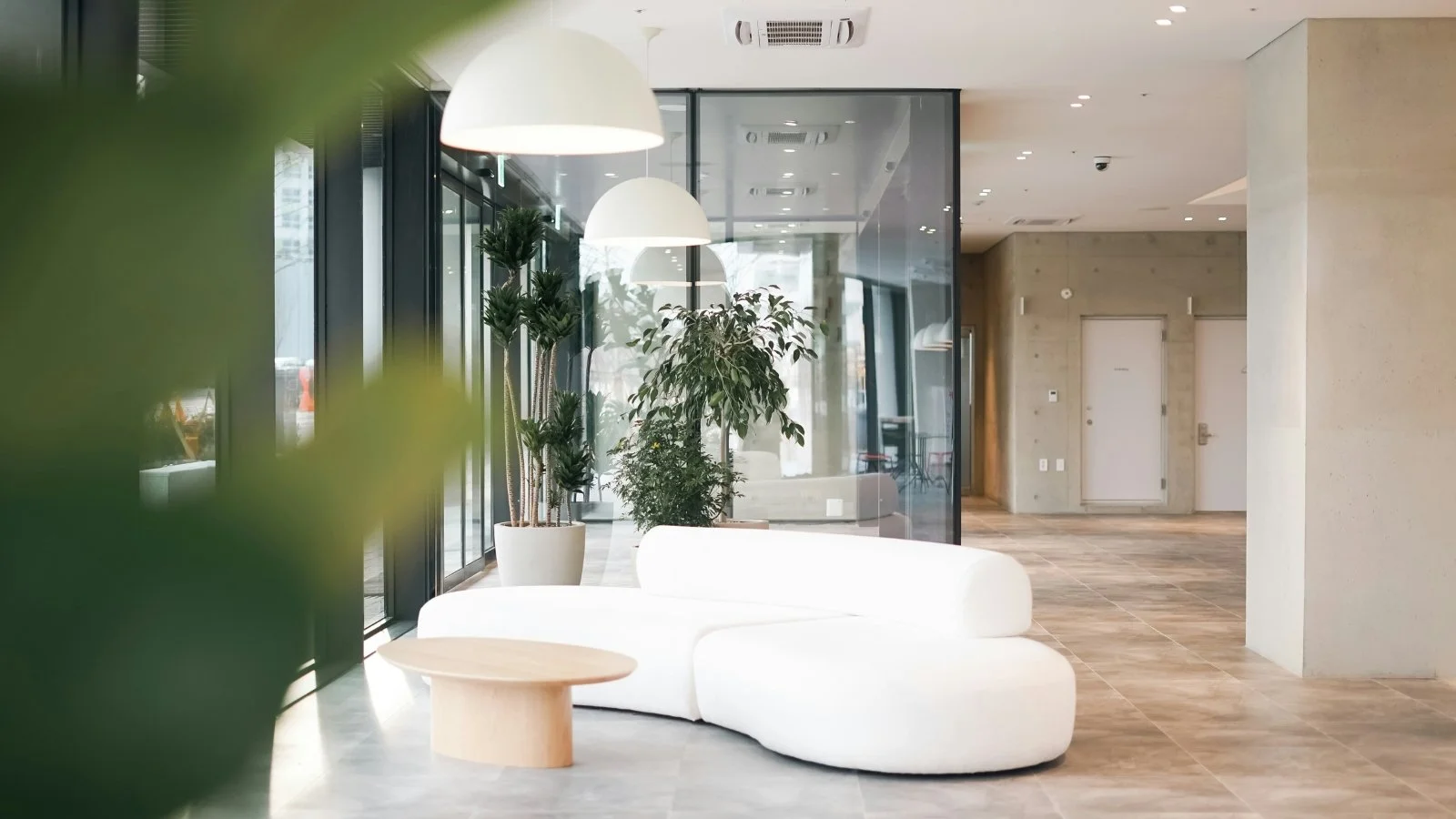 Modern lobby with a large sofa and natural lighting