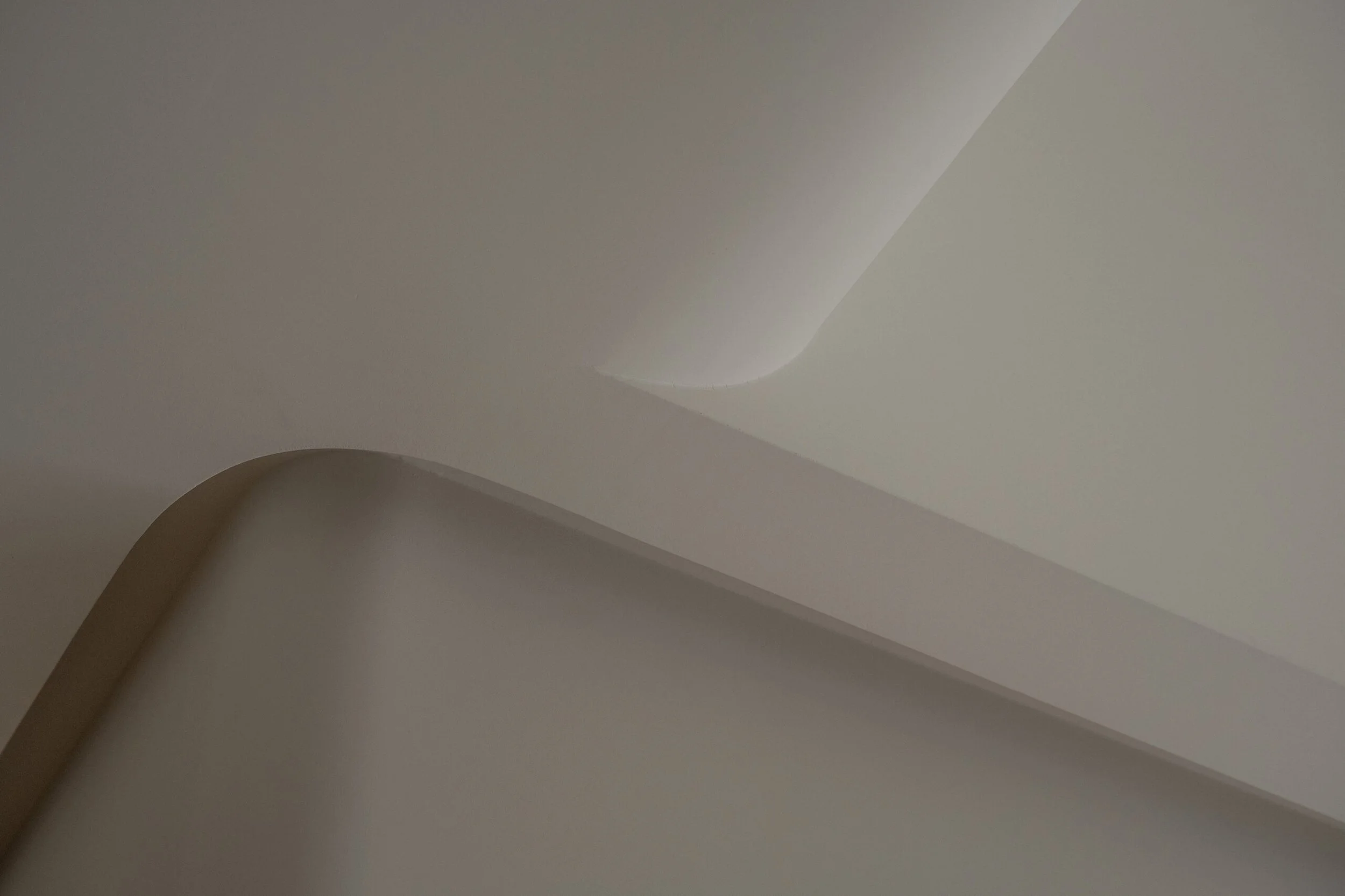 Close-up of layered, curved white paper or material with soft shadows and highlights.
