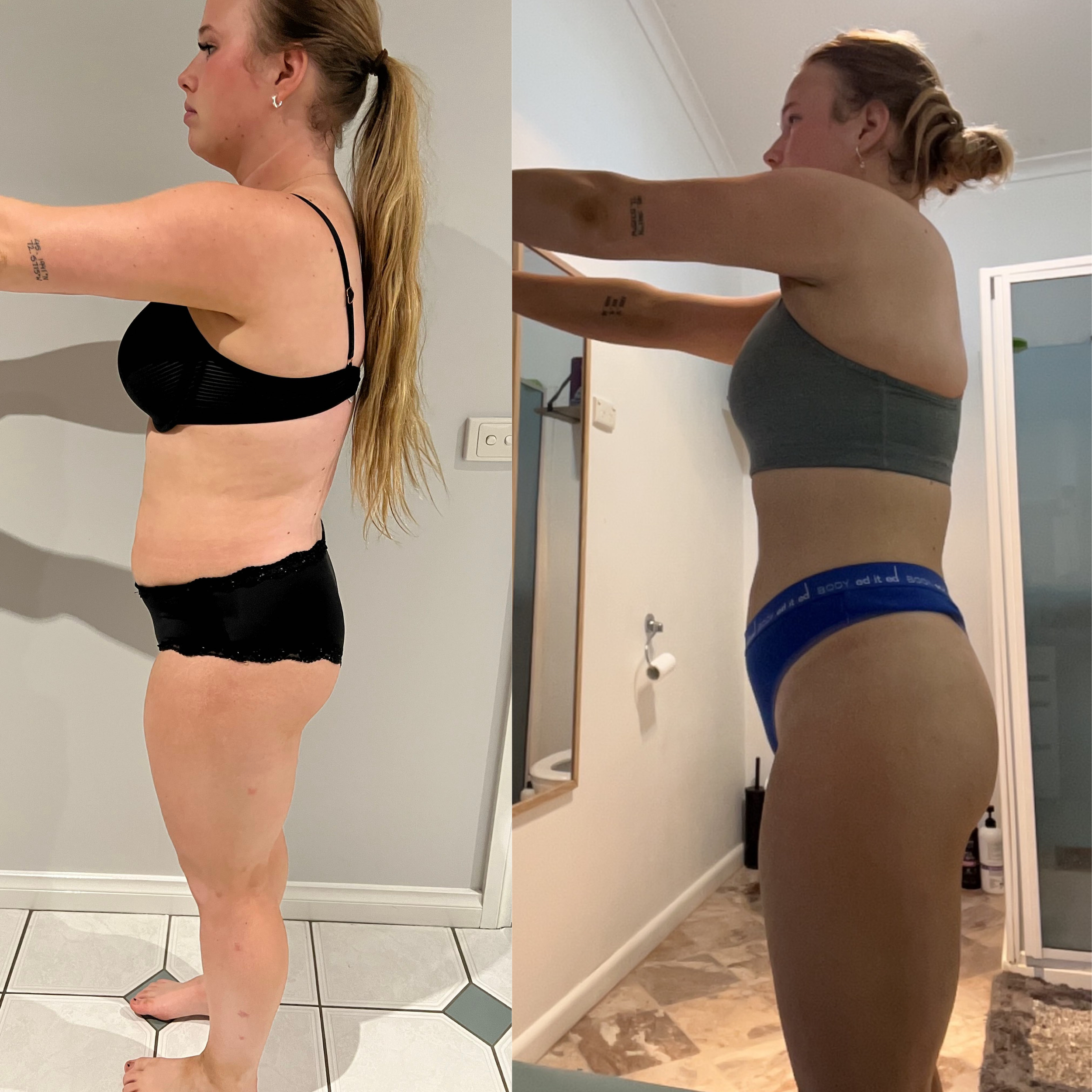 A side view of a woman with long blonde hair tied in a ponytail, wearing a black sports bra and black shorts, standing in a room with tiled floors and a white wall. In another room, her reflection shows her wearing gray sports bra and blue underwear,