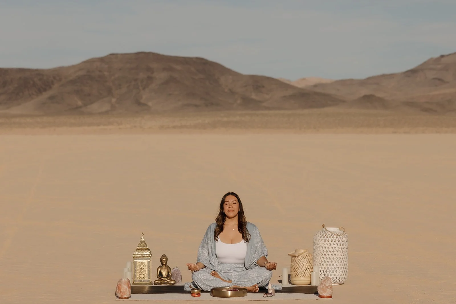 Trauma therapist meditating in the Nevada desert, representing grounding, mindfulness, nervous system regulation, and healing through EMDR therapy.