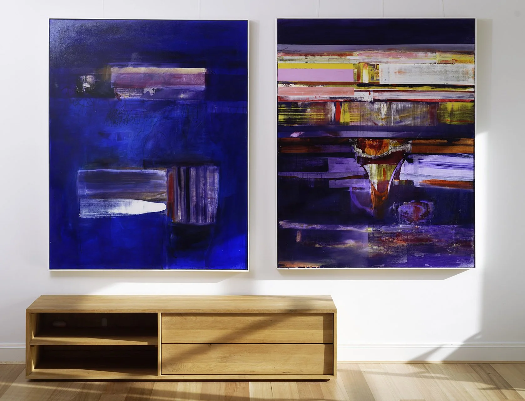 John Waller paintings hung above a timber sideboard