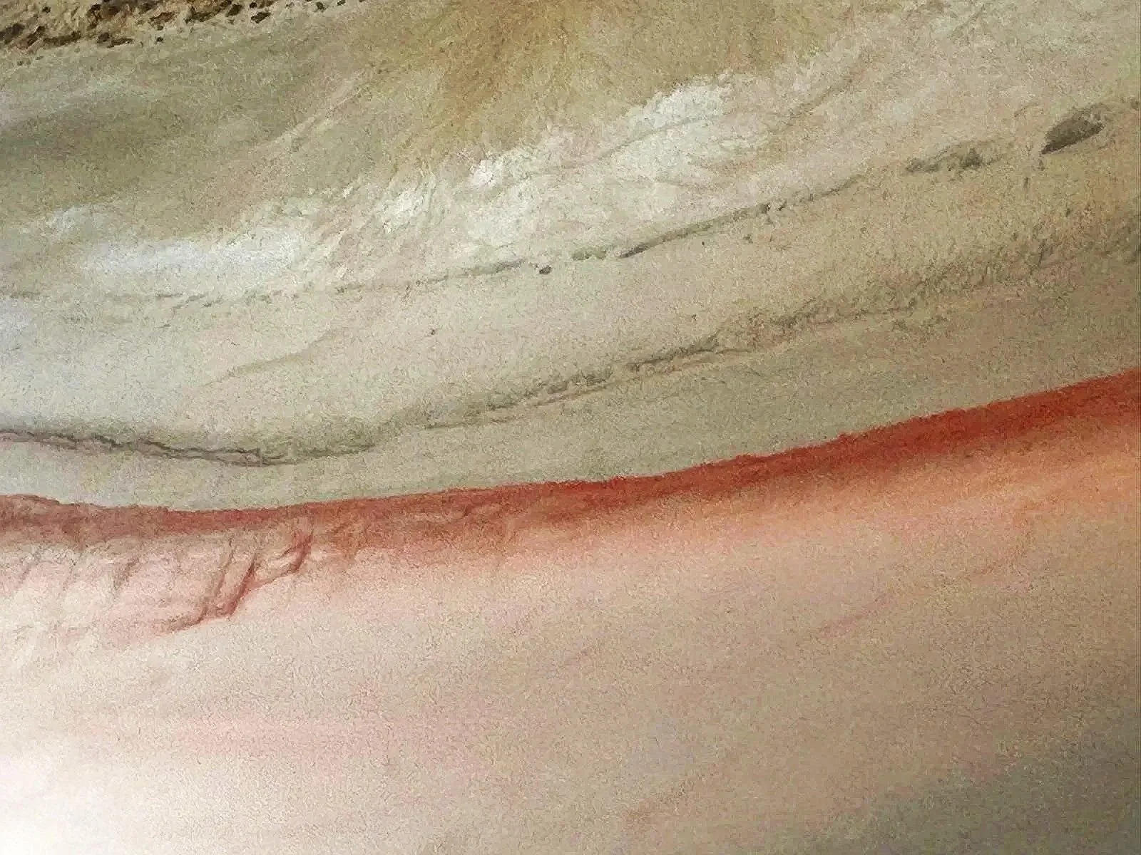 Close-up of a colorful abstract watercolor painting with shades of orange, beige, green, and hints of brown.