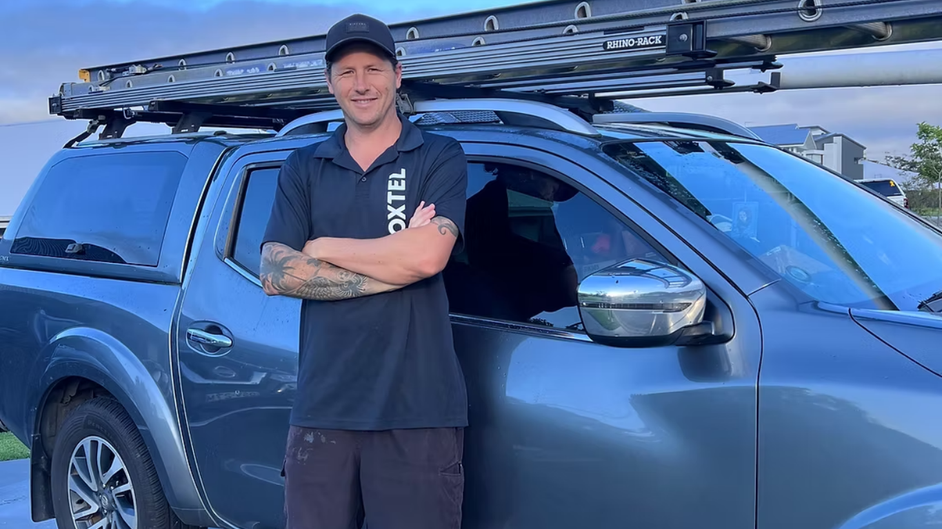 Professional TV antenna installer working on a residential roof in Central Coast NSW