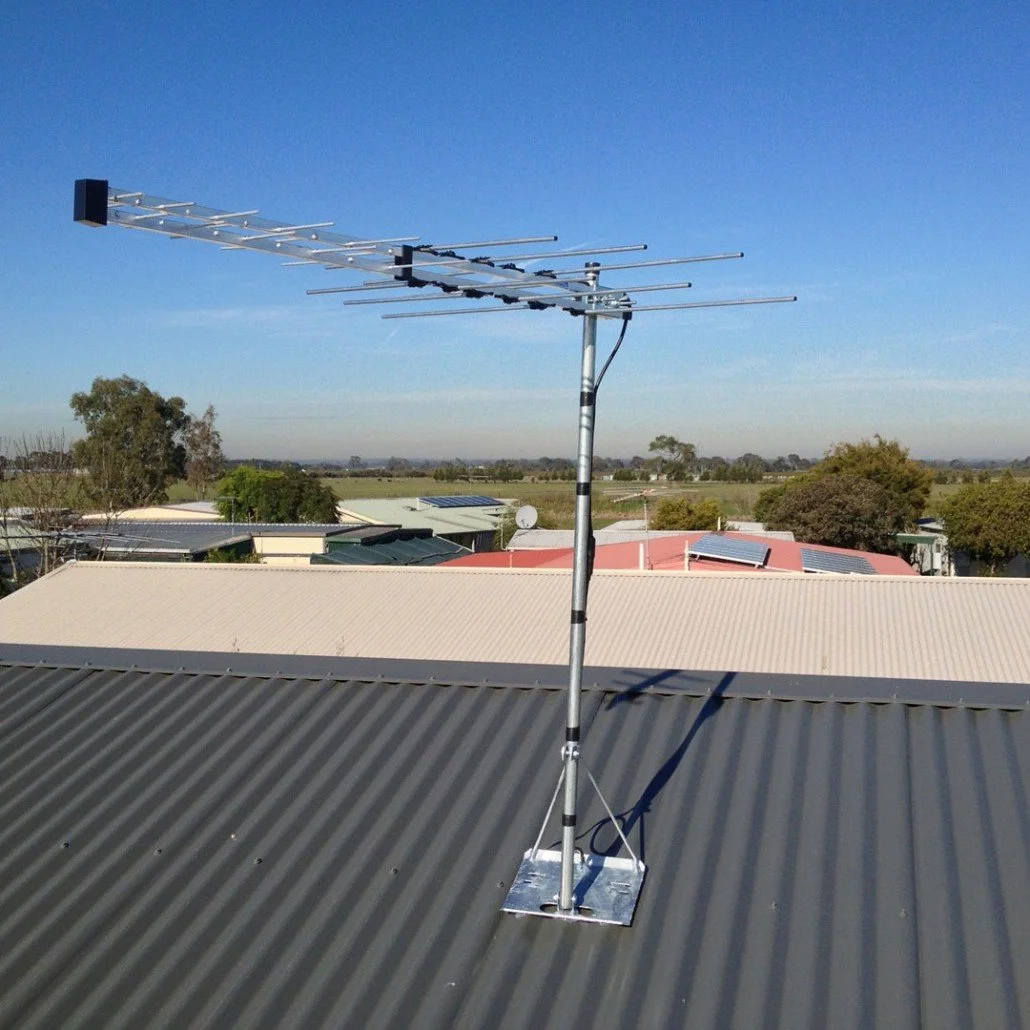 Technician securing a rooftop tv aerial antenna for long-lasting performance