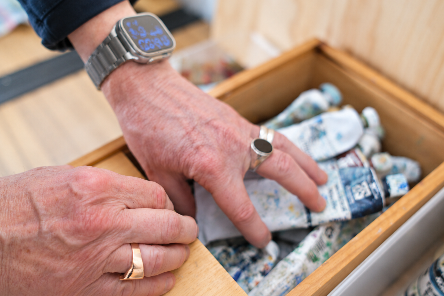 Hands in acrylic box (brighter).png