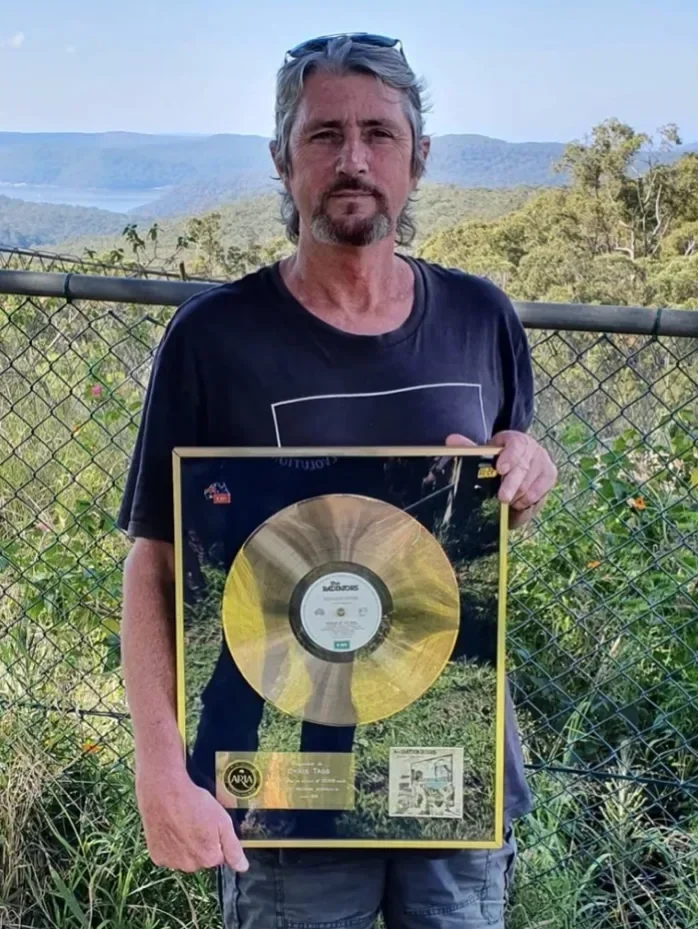 Former Rads drummer, Chis Tagg, reunited with his gold record for Scream of the Real, April 2021. With thanks to Mal Brown