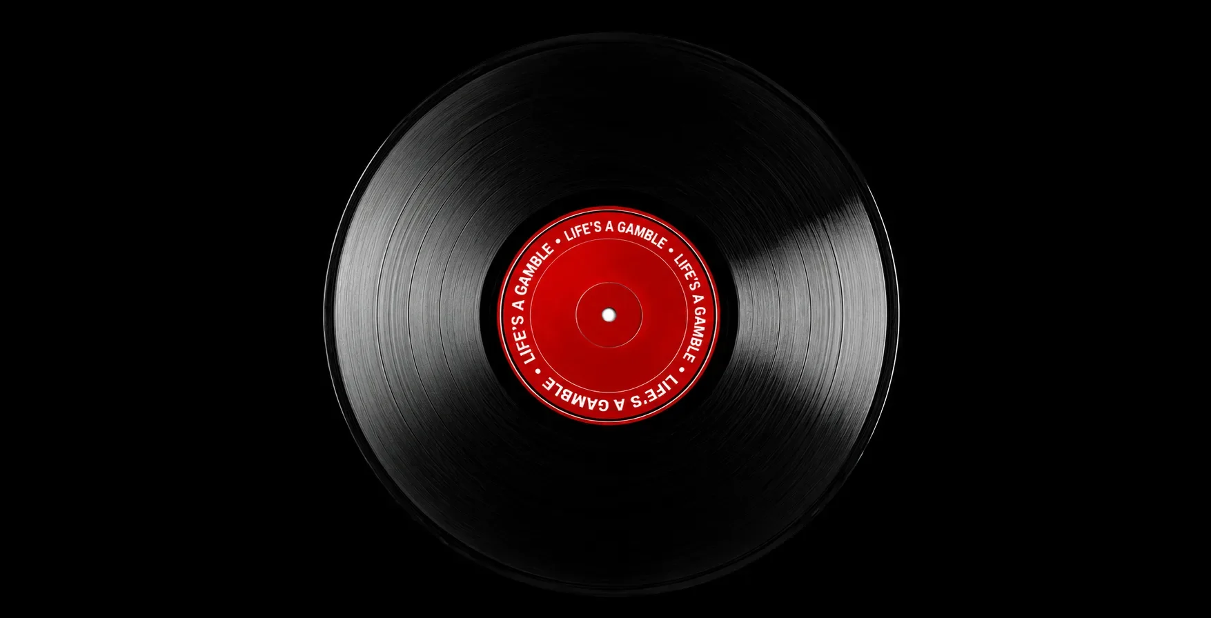A black record with red centre, where the Life's A Gamble memoir title is written repeatedly. This record is featured on a black background.