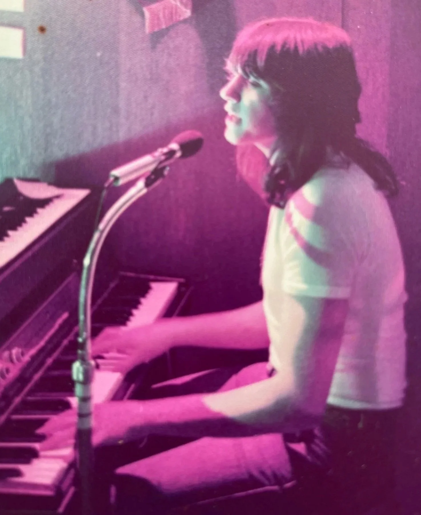Brendan Callinan on piano as a teenager singing into the microphone.