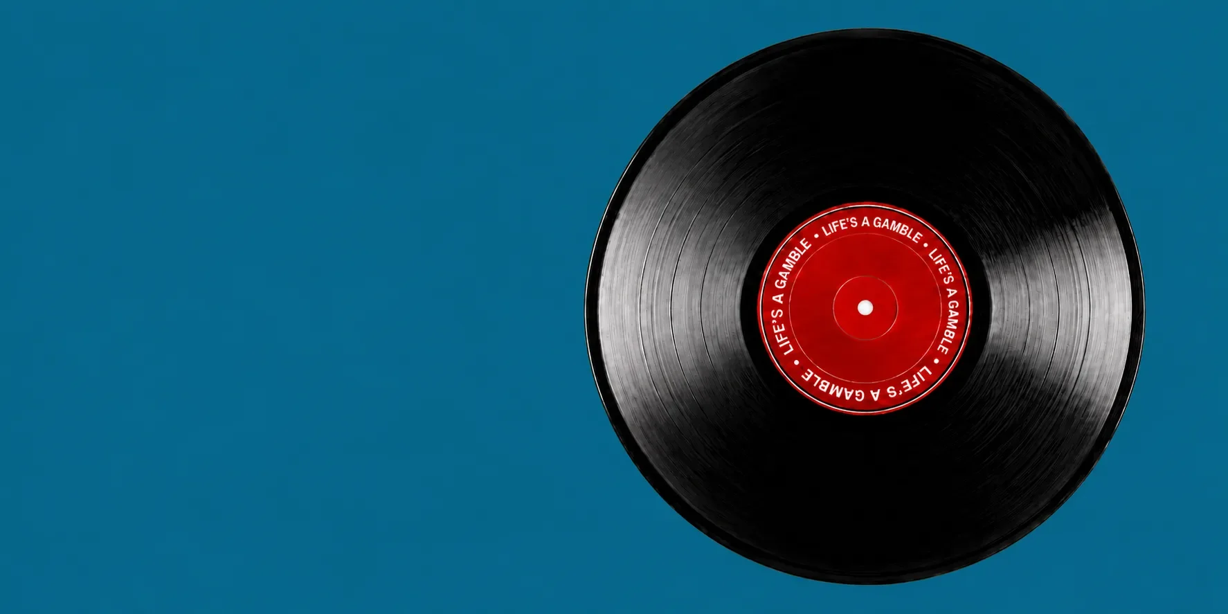 A  record on teal coloured background promoting Brendan Callinan's 'In The Mix' blog. Reflecting on his time in the electric 80s up to today as a music industry musician and professional consultant.